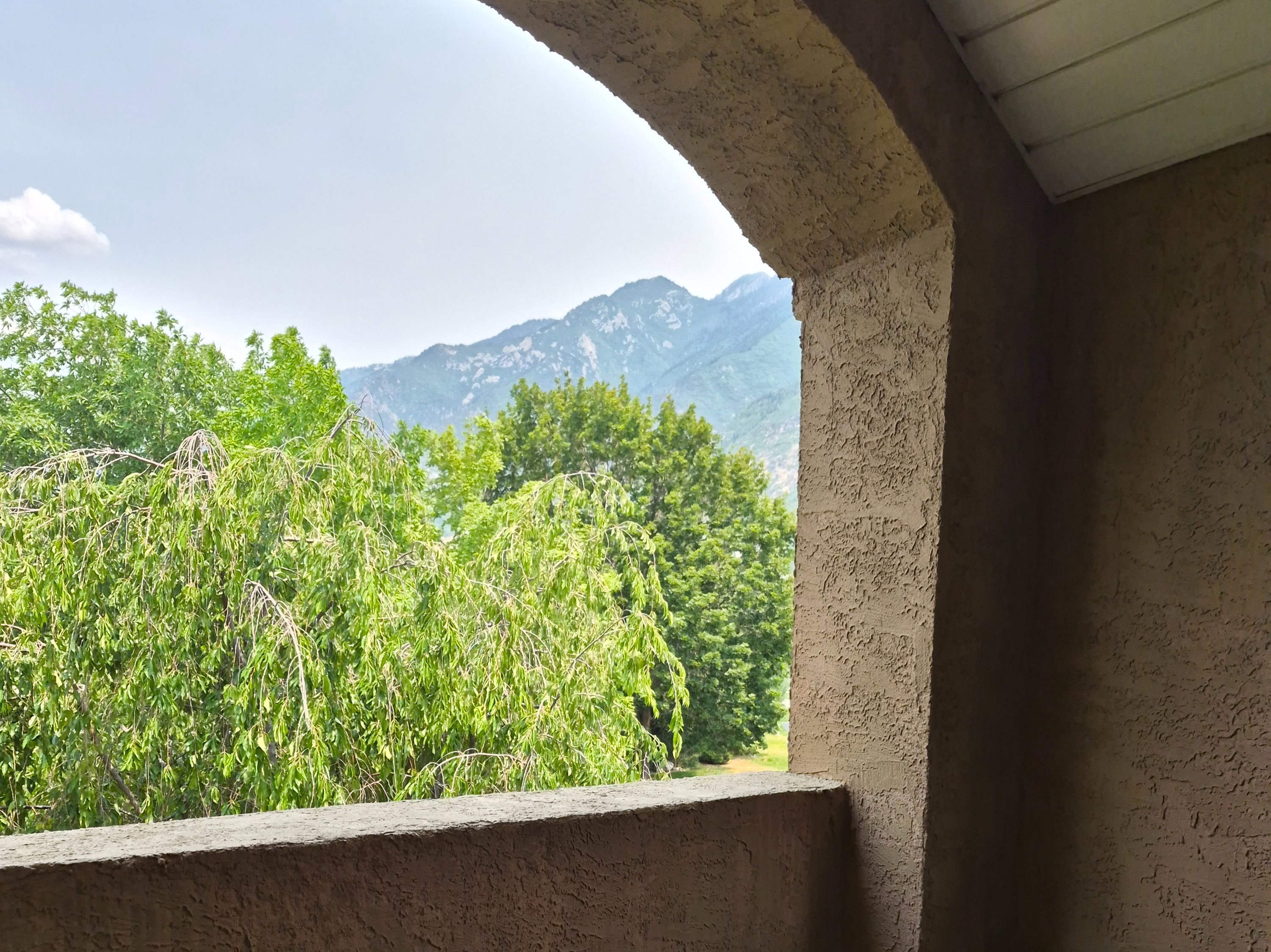 Covered balcony featuring a view of the mountains