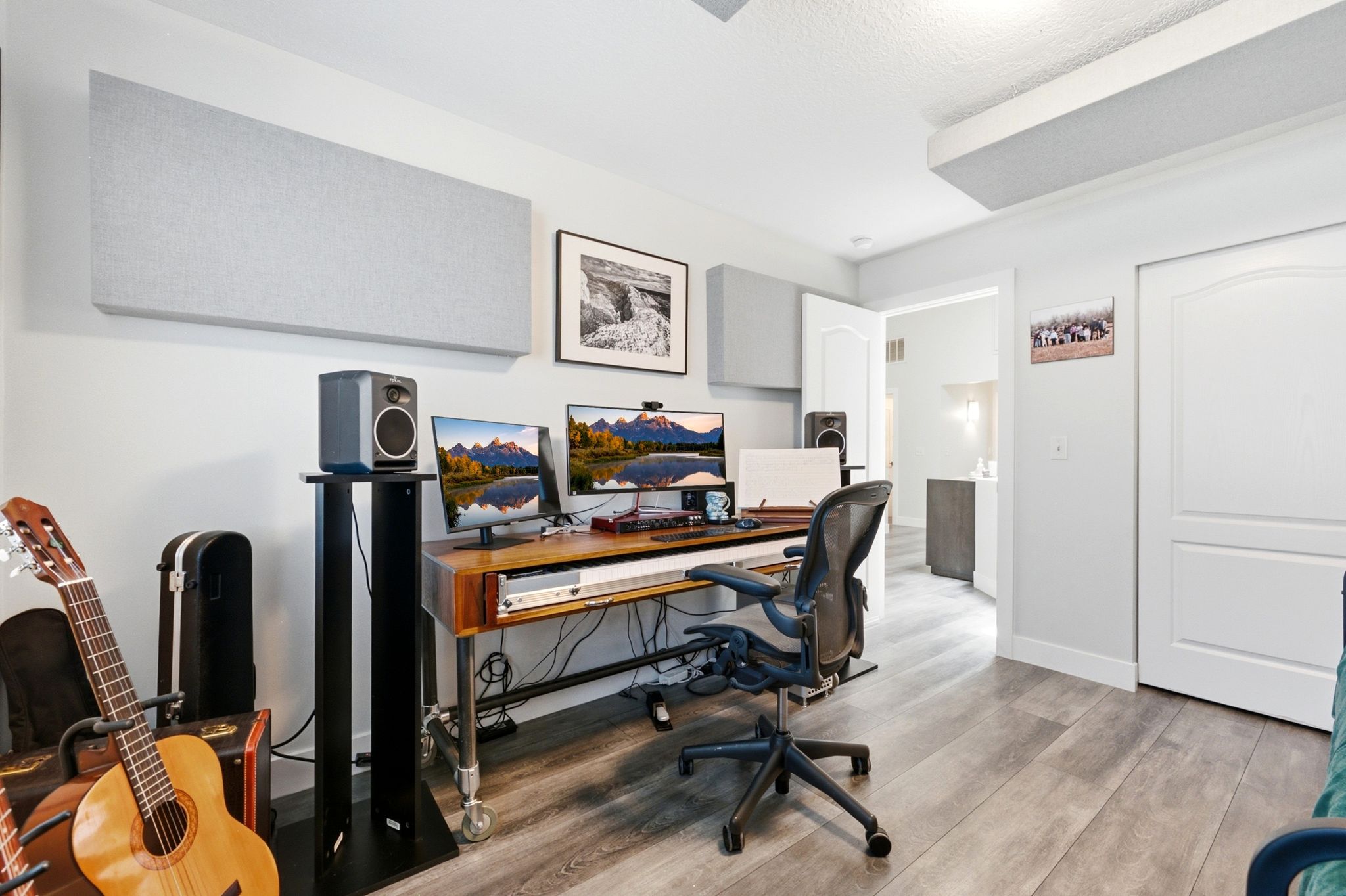 Dedicated workspace featuring wood-finish flooring, white walls, and a recessed light fixture