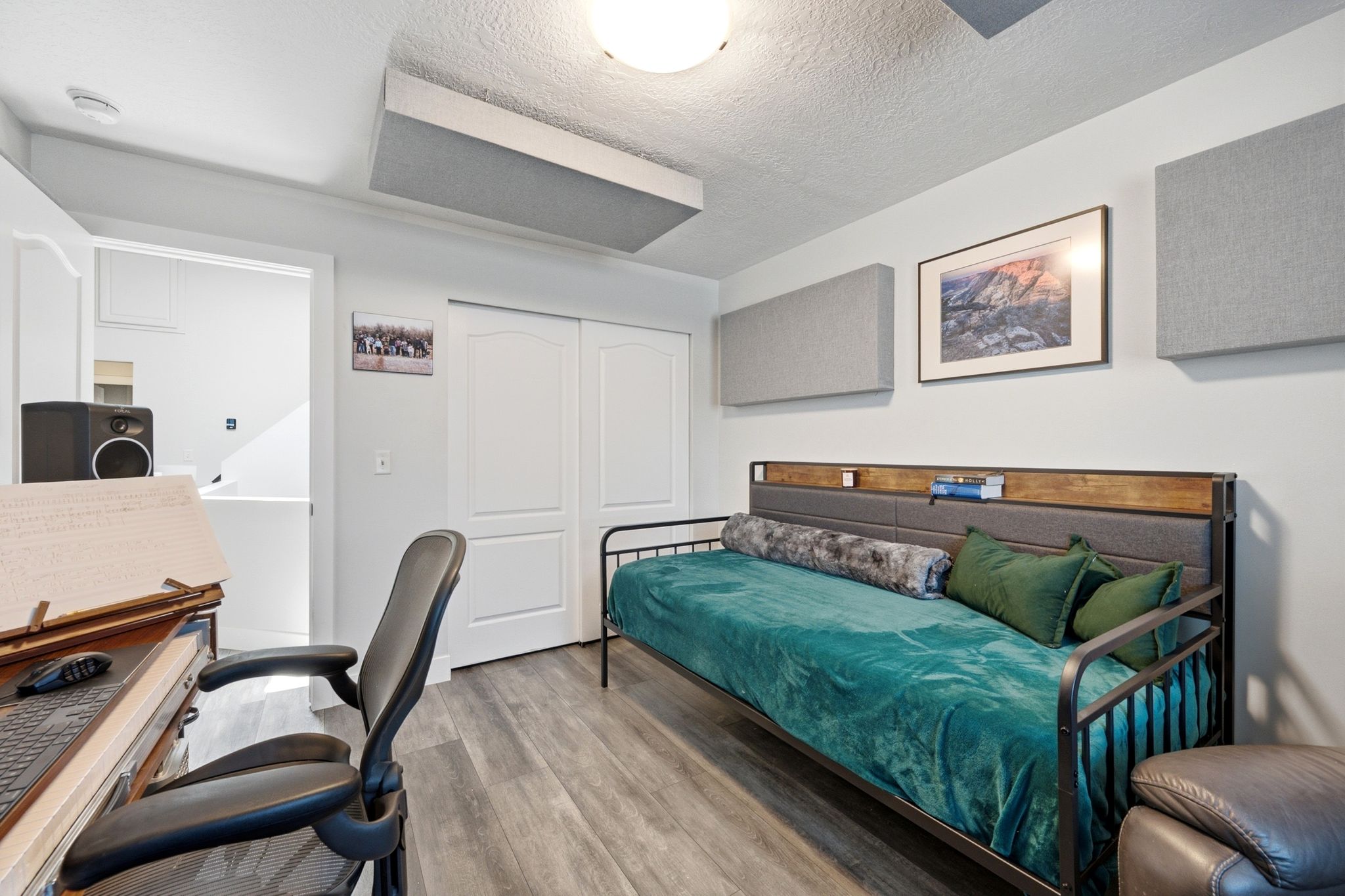 Interior room featuring wood-finish flooring, white walls, and a ceiling-mounted light fixture