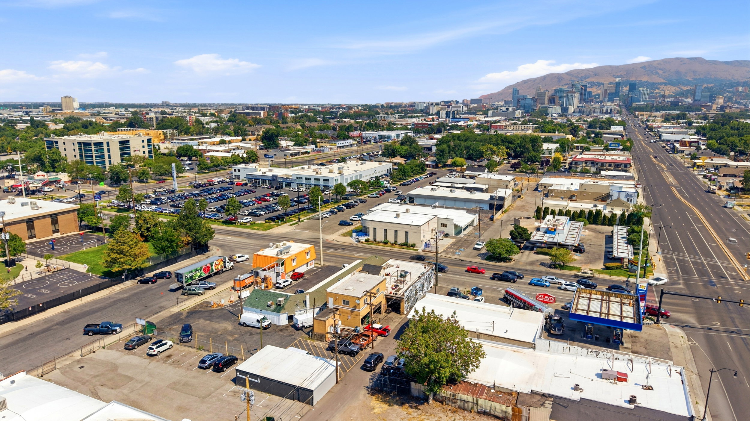 Aerial perspective showcasing an urban environment with commercial buildings and arterial roads
