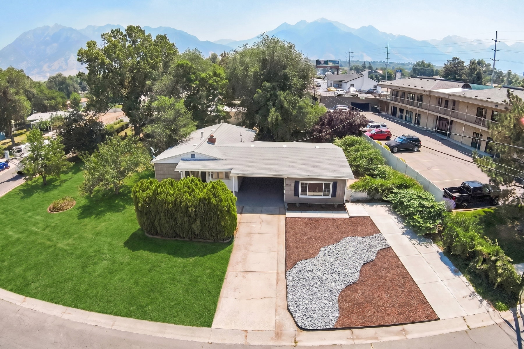 Single-story residence featuring a front-facing garage, a concrete driveway, and a manicured lawn