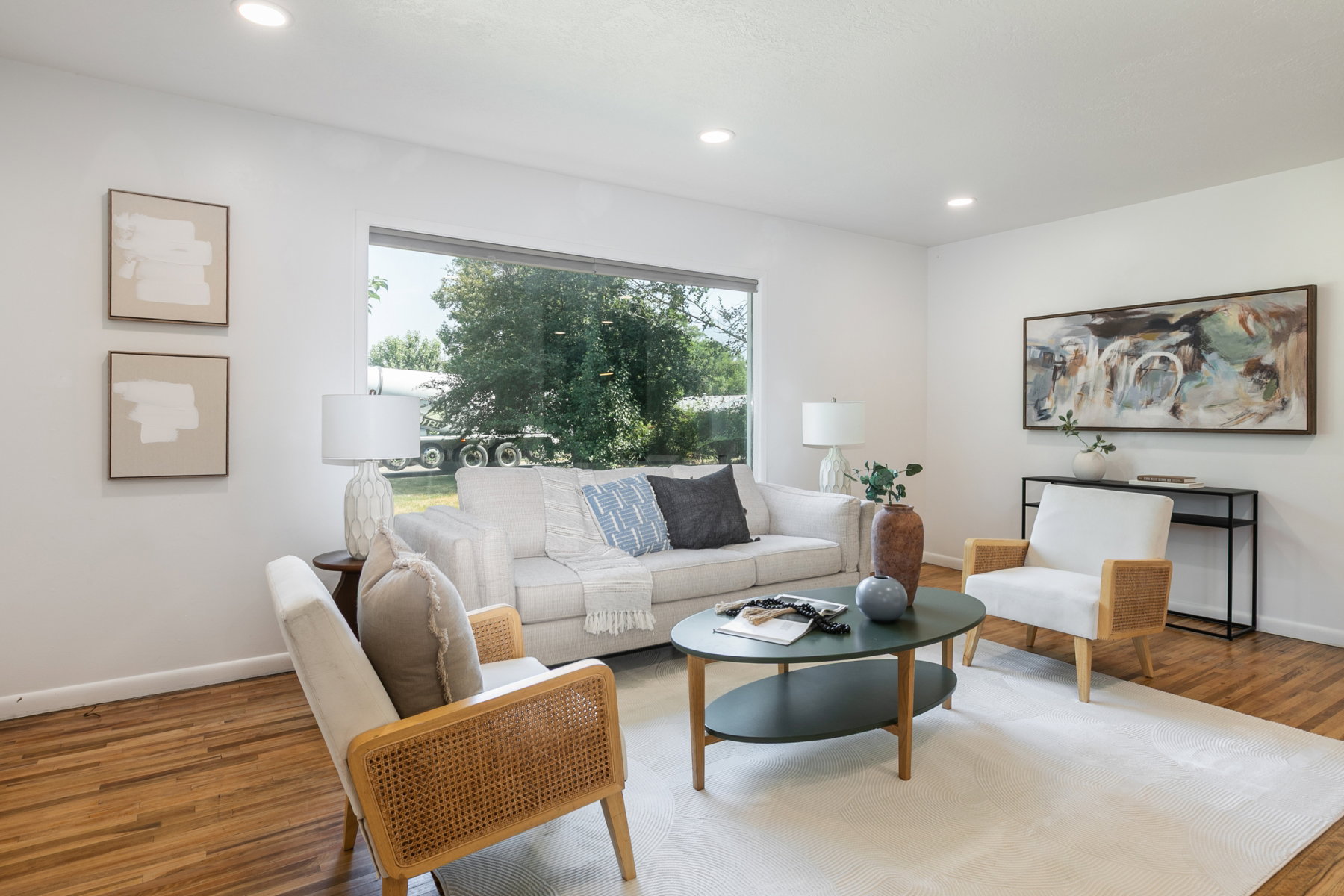 Living area featuring wood-finish flooring, recessed lighting, and a large picture window