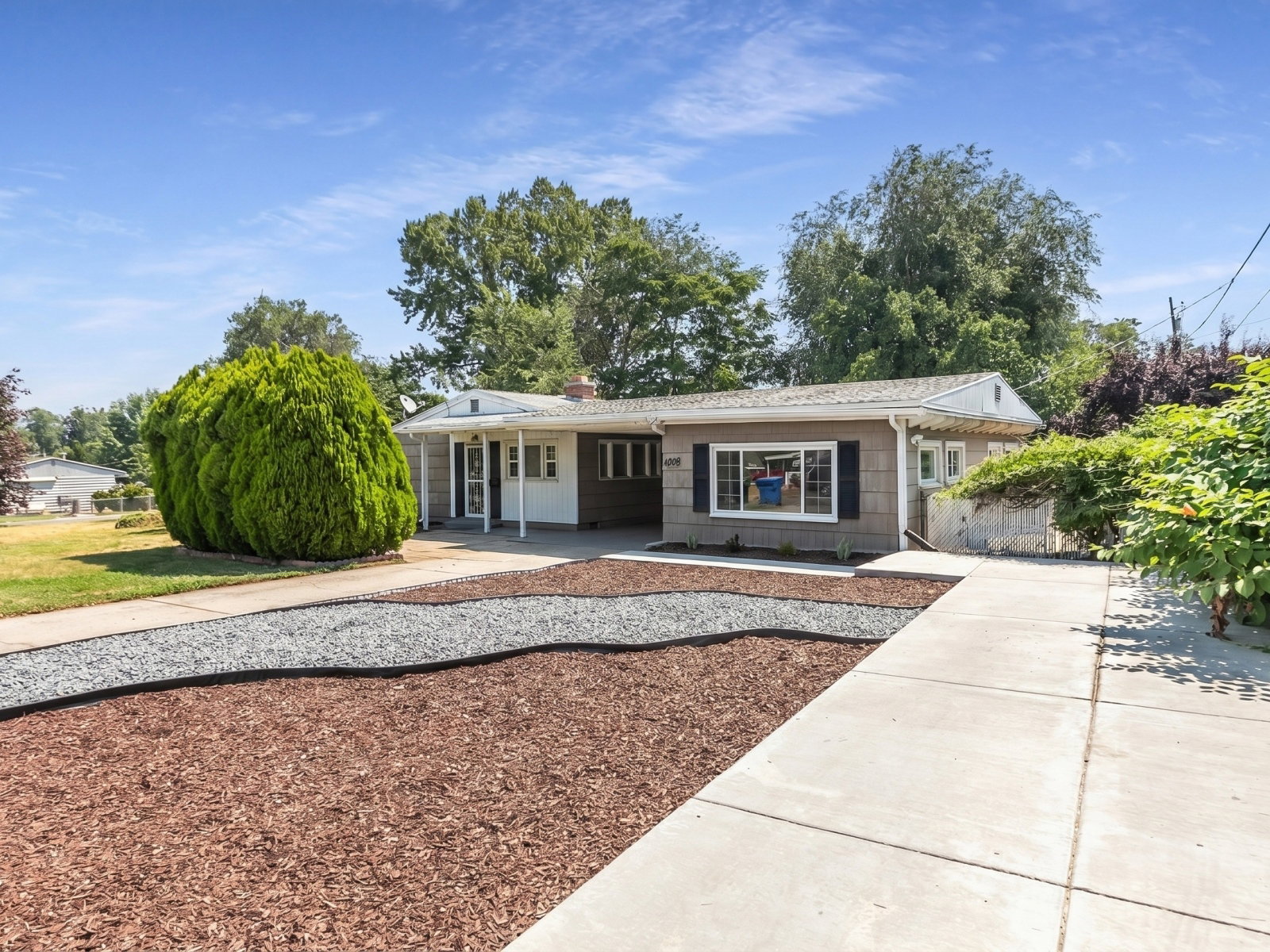 Single-story residence featuring a gray exterior and white trim