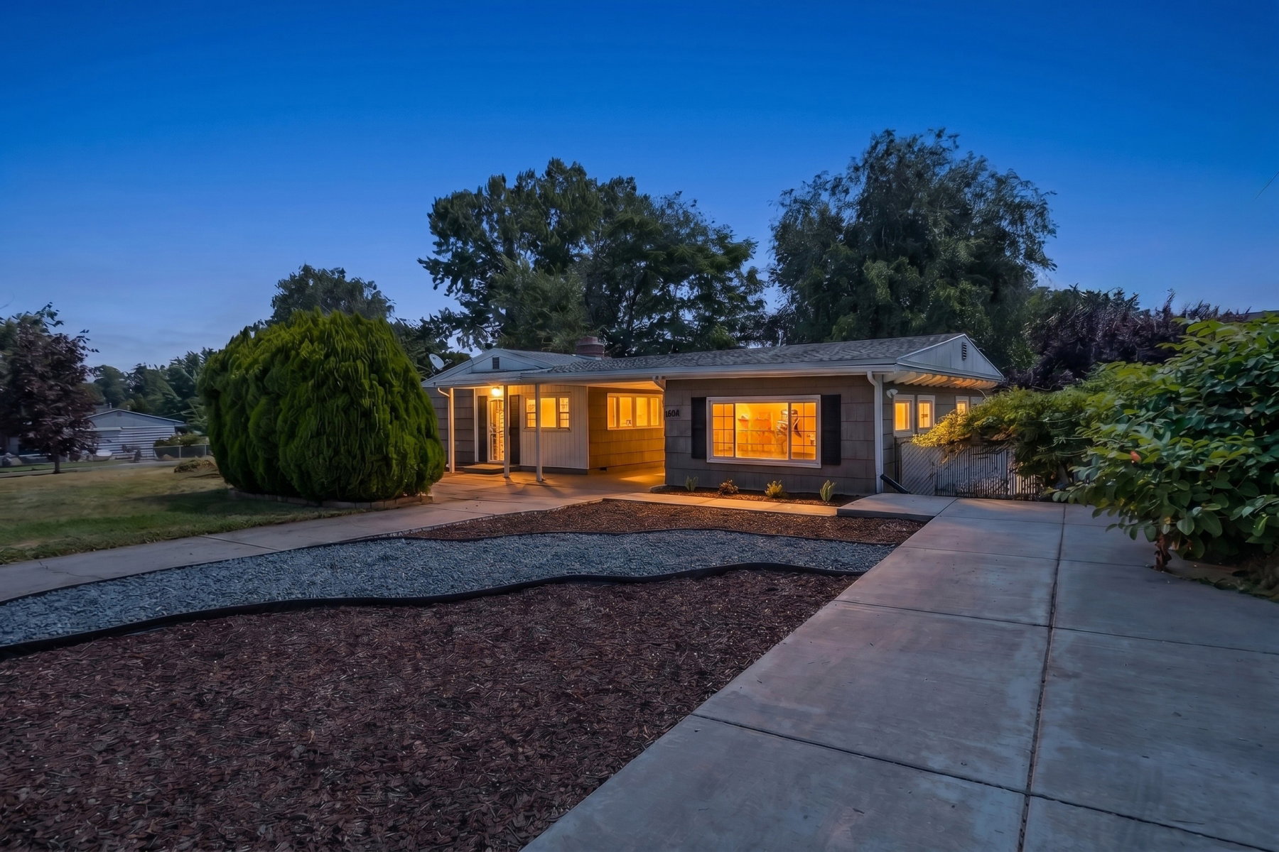 Ranch-style exterior with a covered entry and a concrete driveway