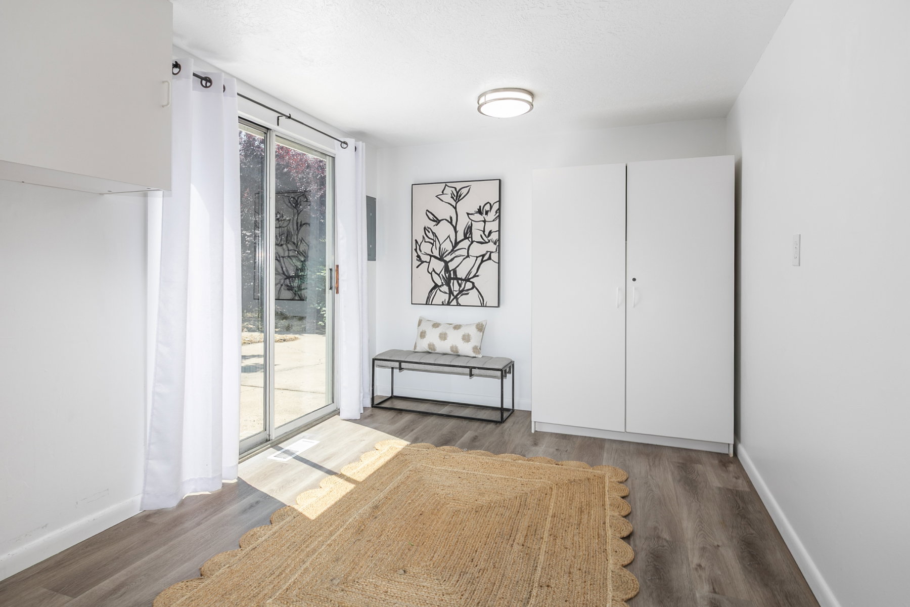 Interior room featuring wood-finish flooring and a sliding glass door