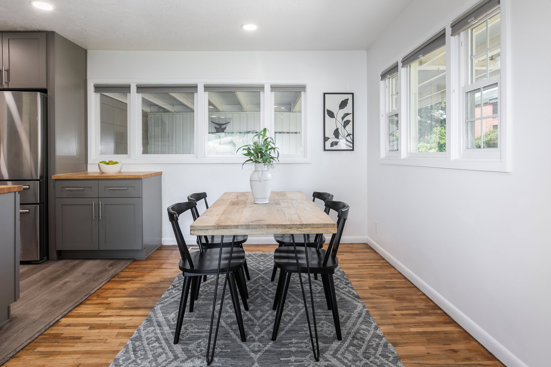 Dining area featuring natural wood-finish flooring and multiple windows
