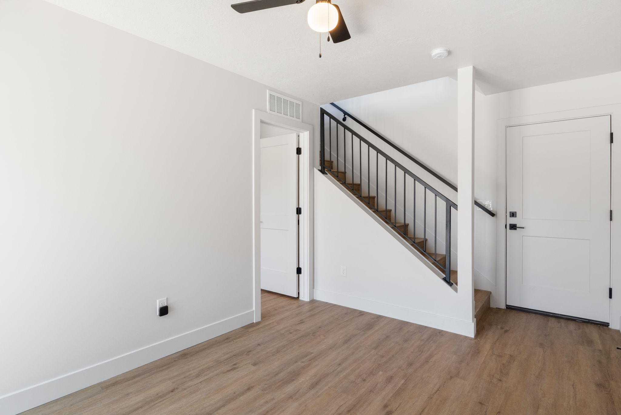 View of garage door on the right and bedroom/den to the left