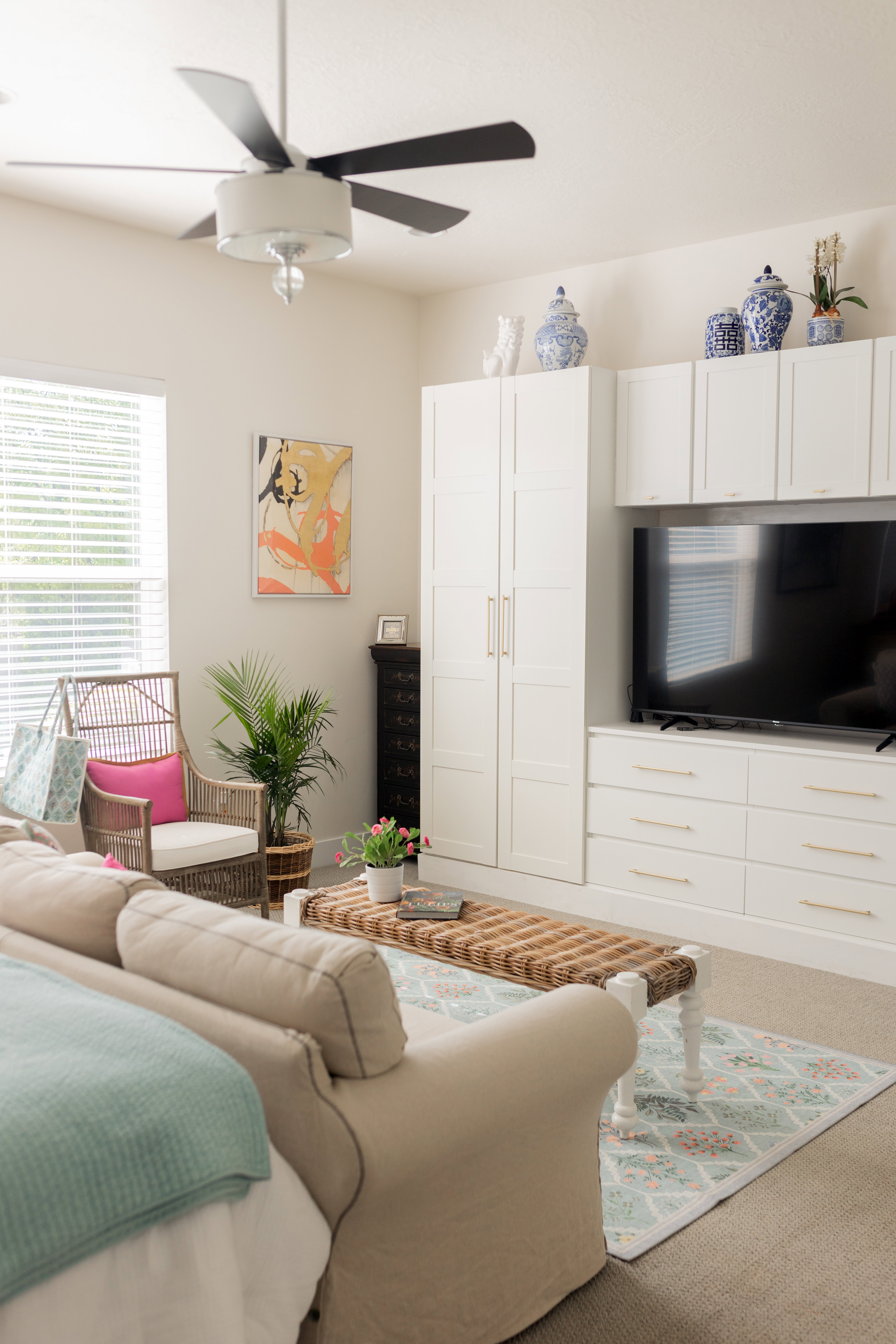 Primary bedroom on main floor. Built-in media center with white cabinetry.