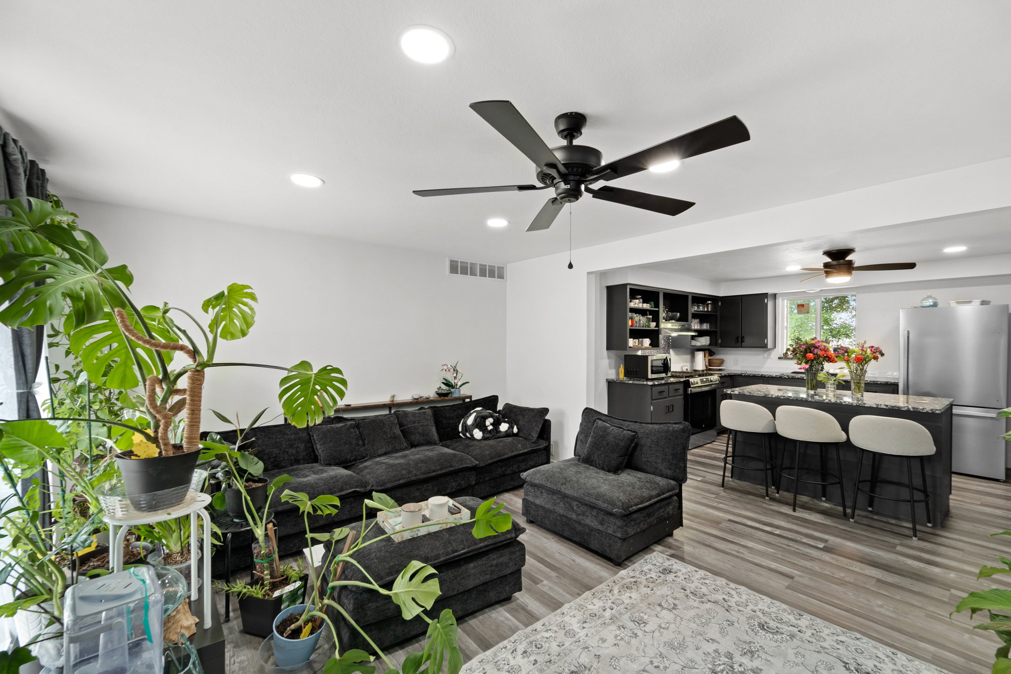 Open-concept living space featuring wood-finish flooring and recessed lighting