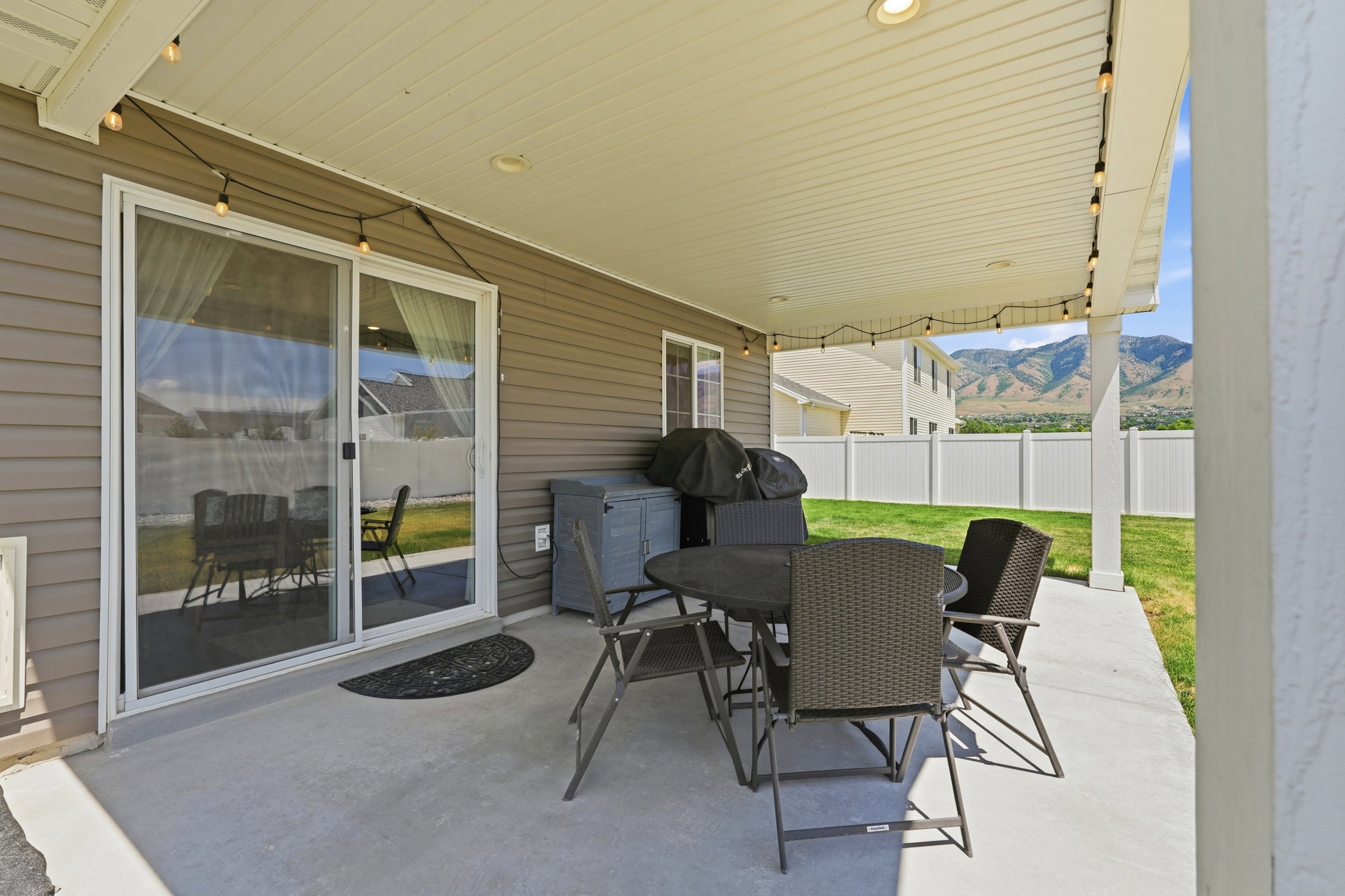 Covered patio featuring a concrete slab, exterior siding, and a sliding glass door