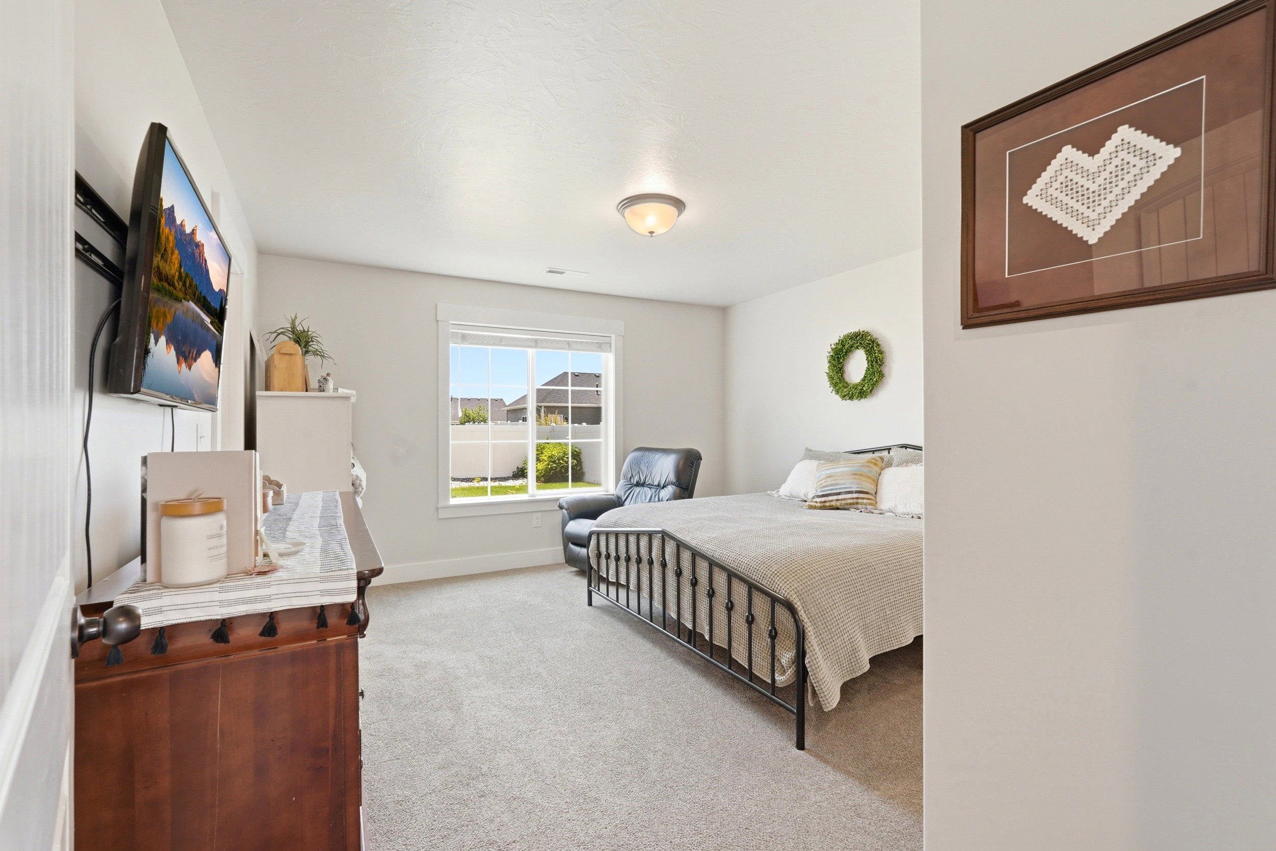 Carpeted room featuring a double window, ceiling-mounted light fixture, and white painted walls