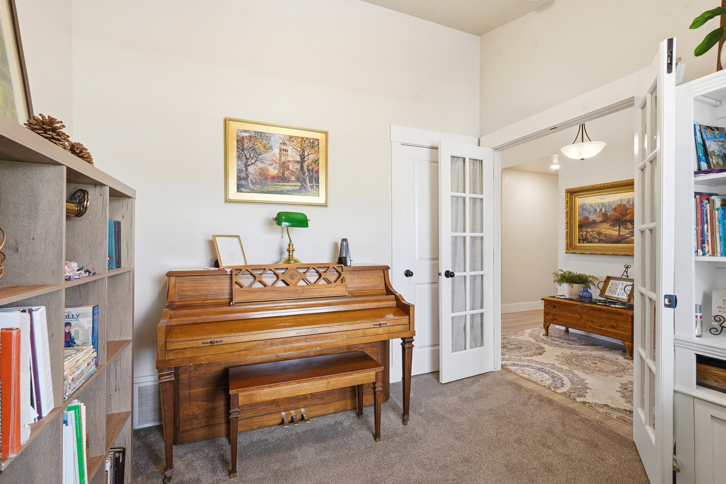 Interior space featuring plush carpet flooring, light-toned wall paint, and white trim work
