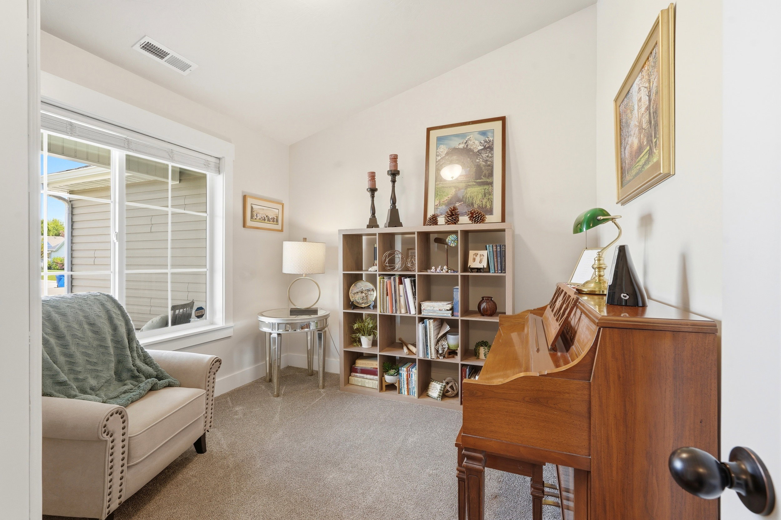 Spacious room featuring light gray carpeting and a large window with white trim