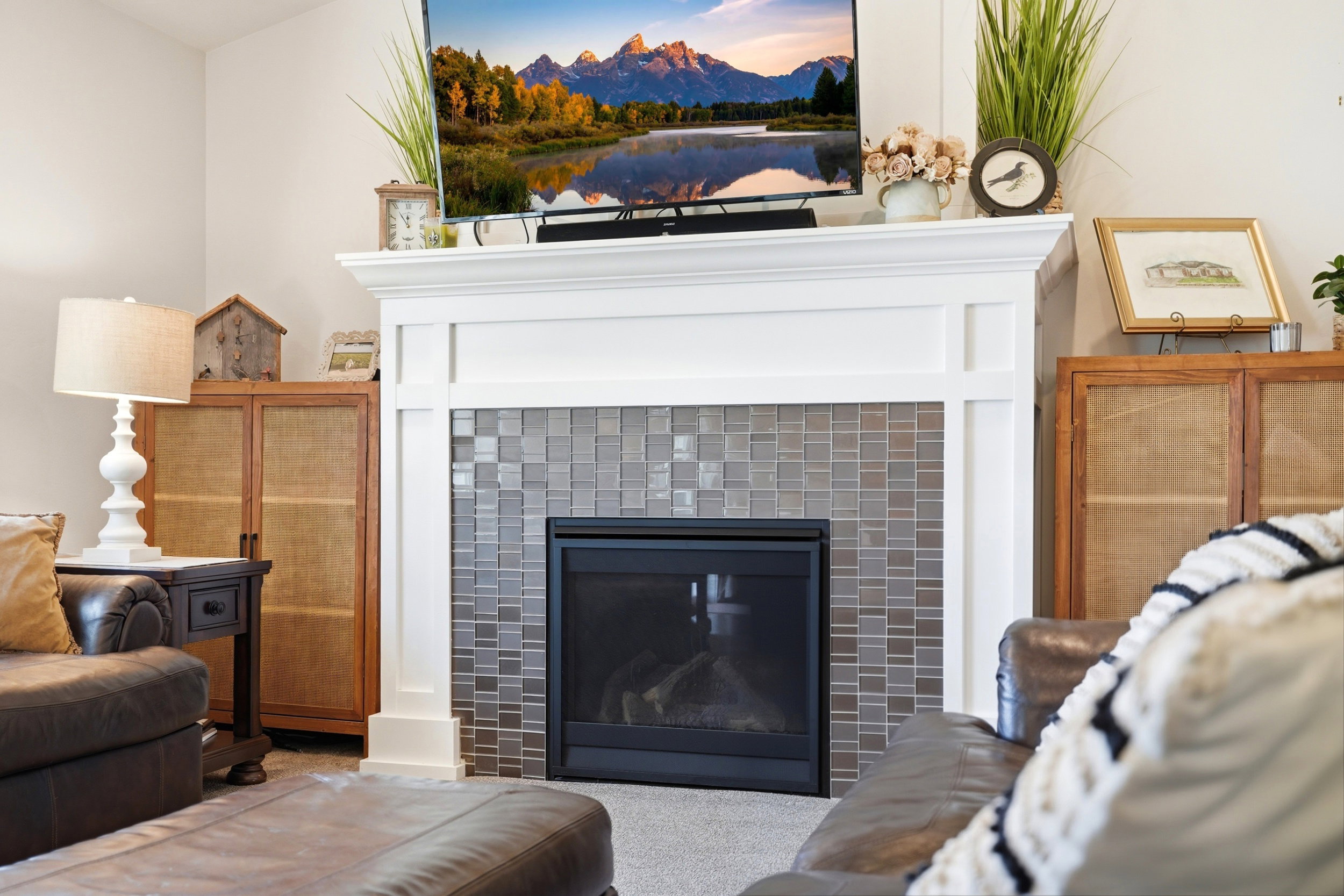 Fireplace featuring a white mantelpiece, mosaic tile surround, and black firebox