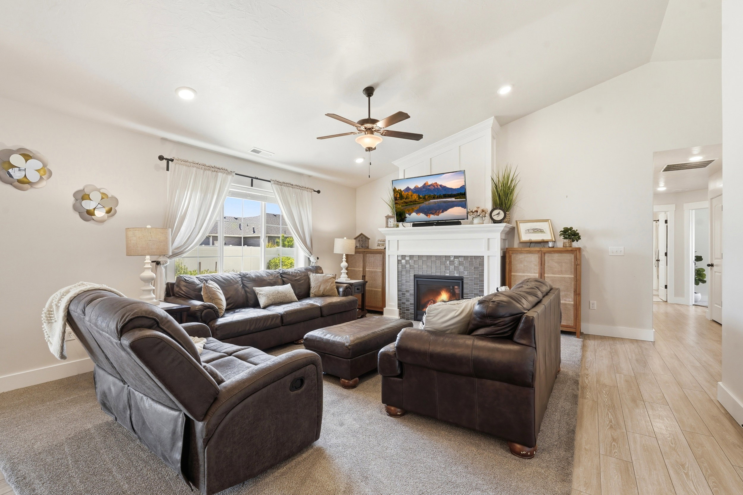 Open-concept living space with a contemporary fireplace featuring a tile surround and a white mantel