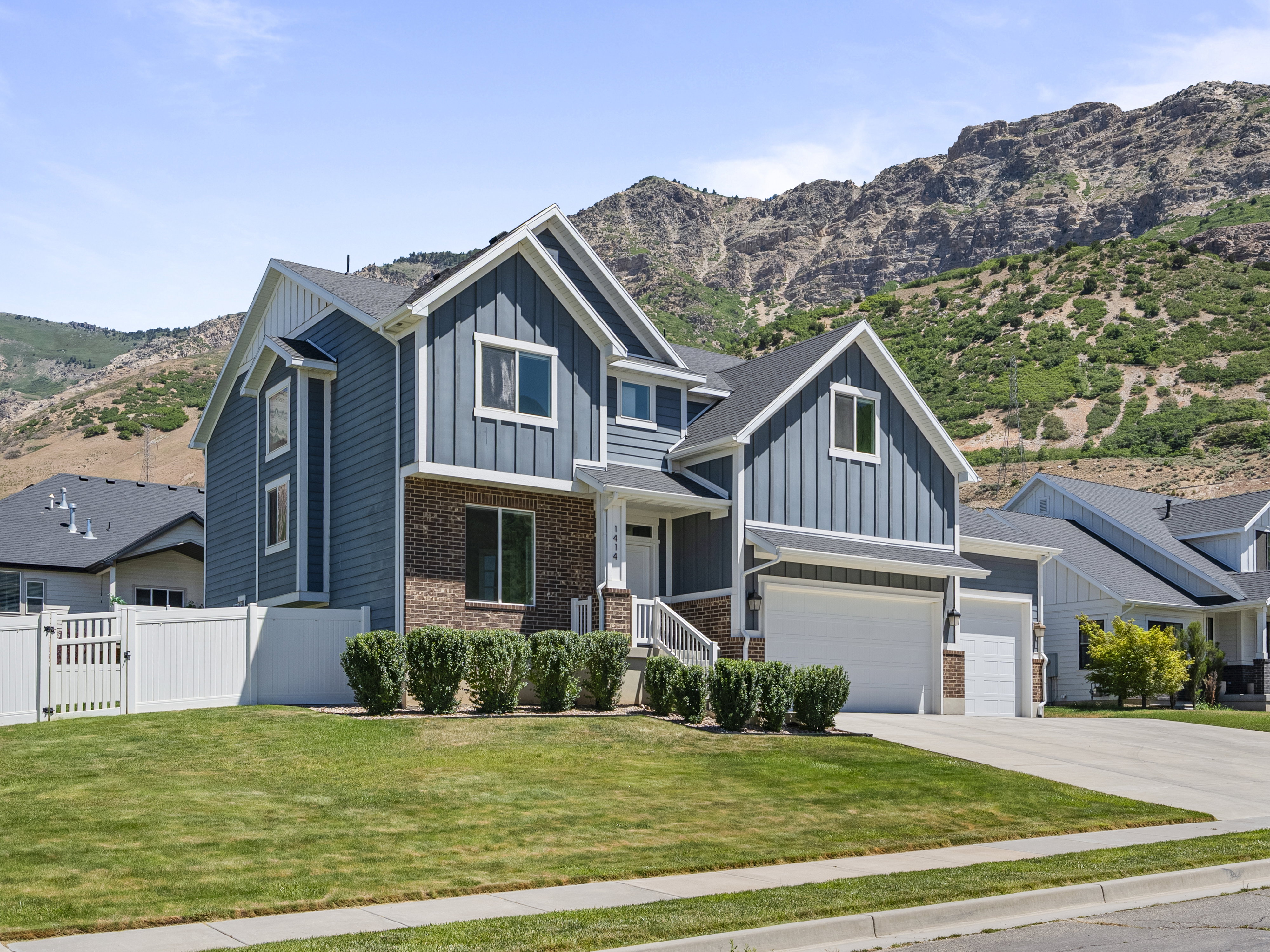 Modern two-story residence featuring blue siding and brick veneer