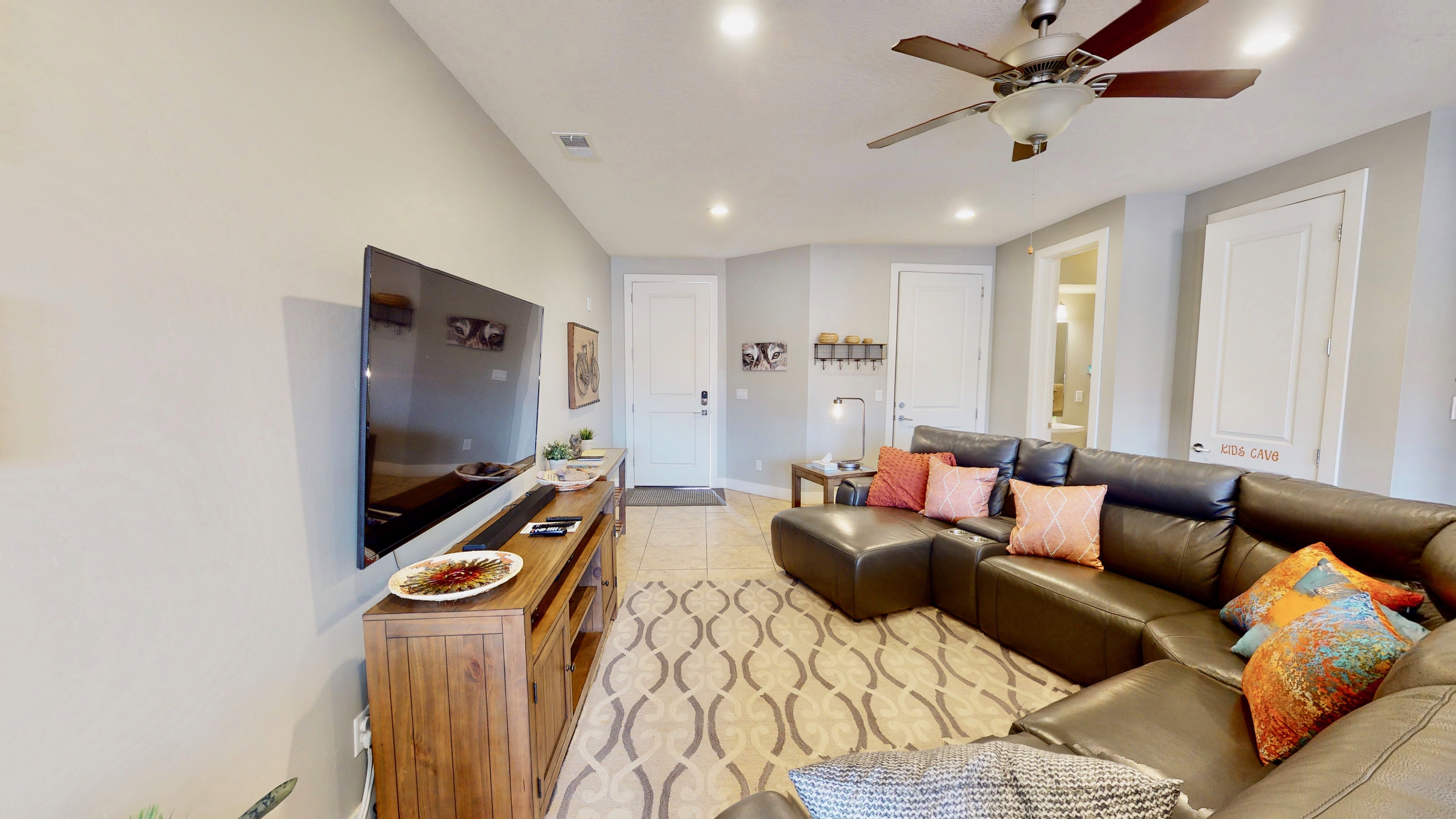 Living area featuring light gray walls, recessed lighting, a ceiling fan, and tile flooring with a decorative rug