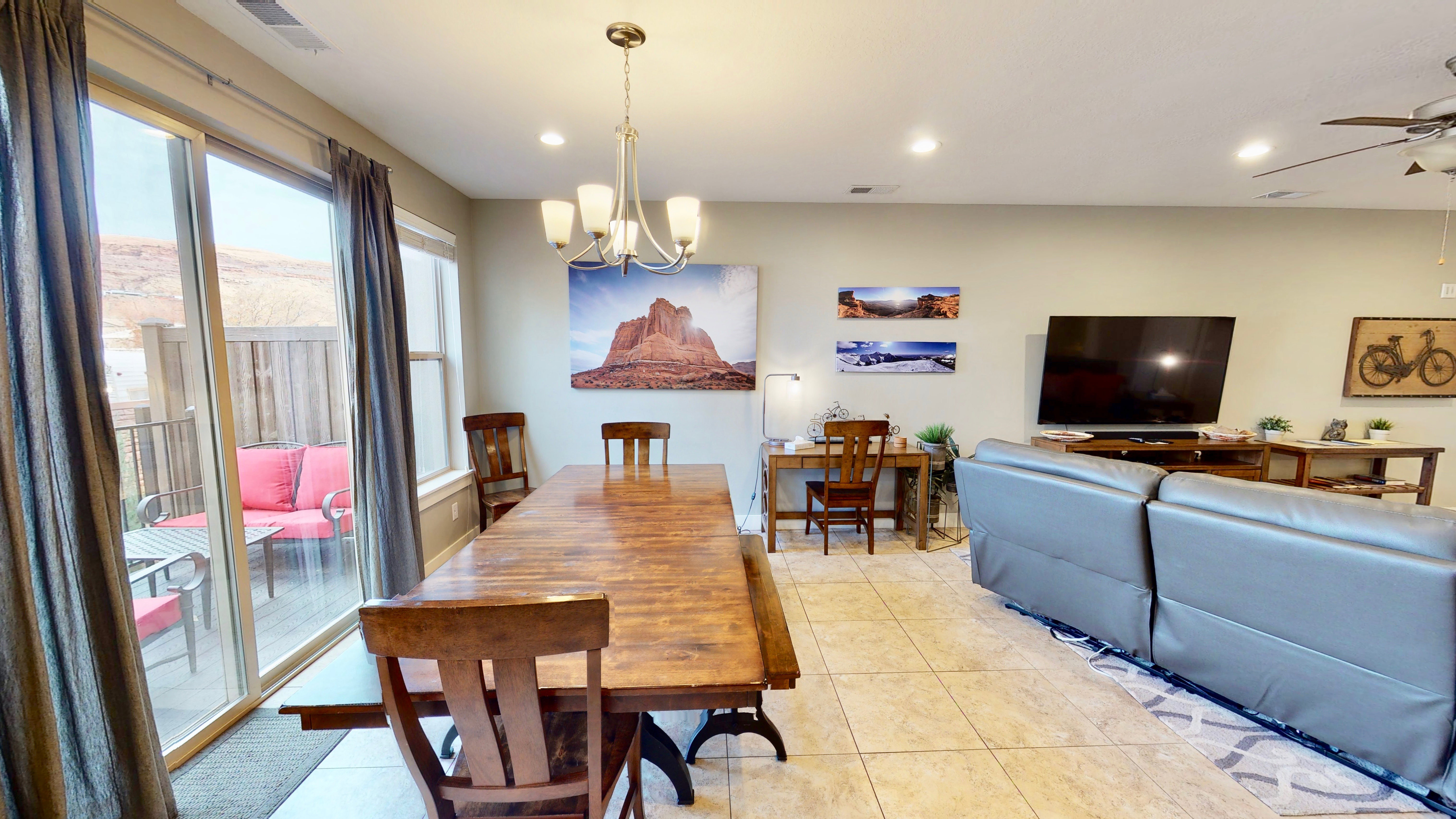 Open-concept living space featuring neutral wall tones, tile flooring, and recessed lighting