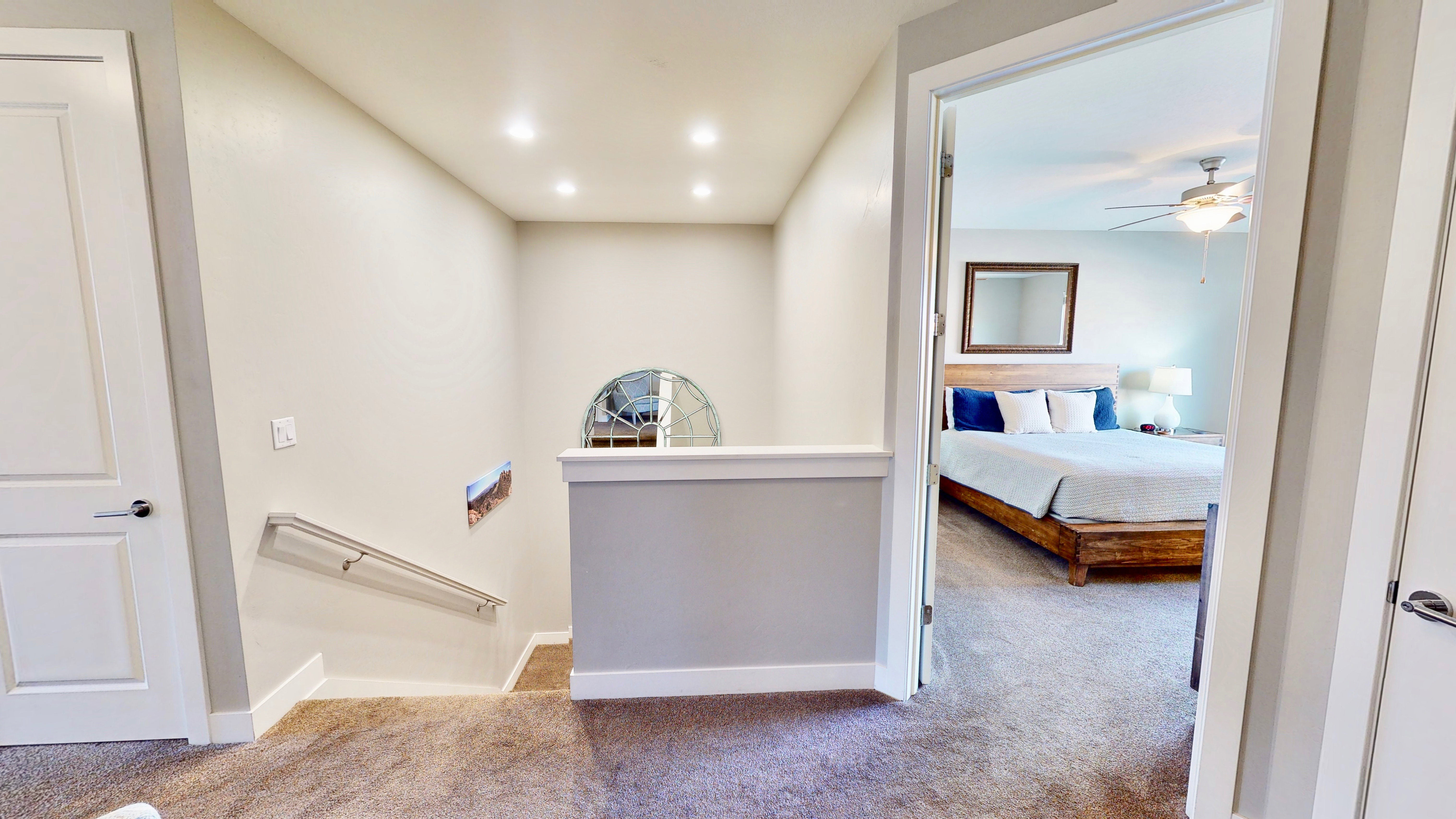 Carpeted hallway with white baseboards and neutral wall paint