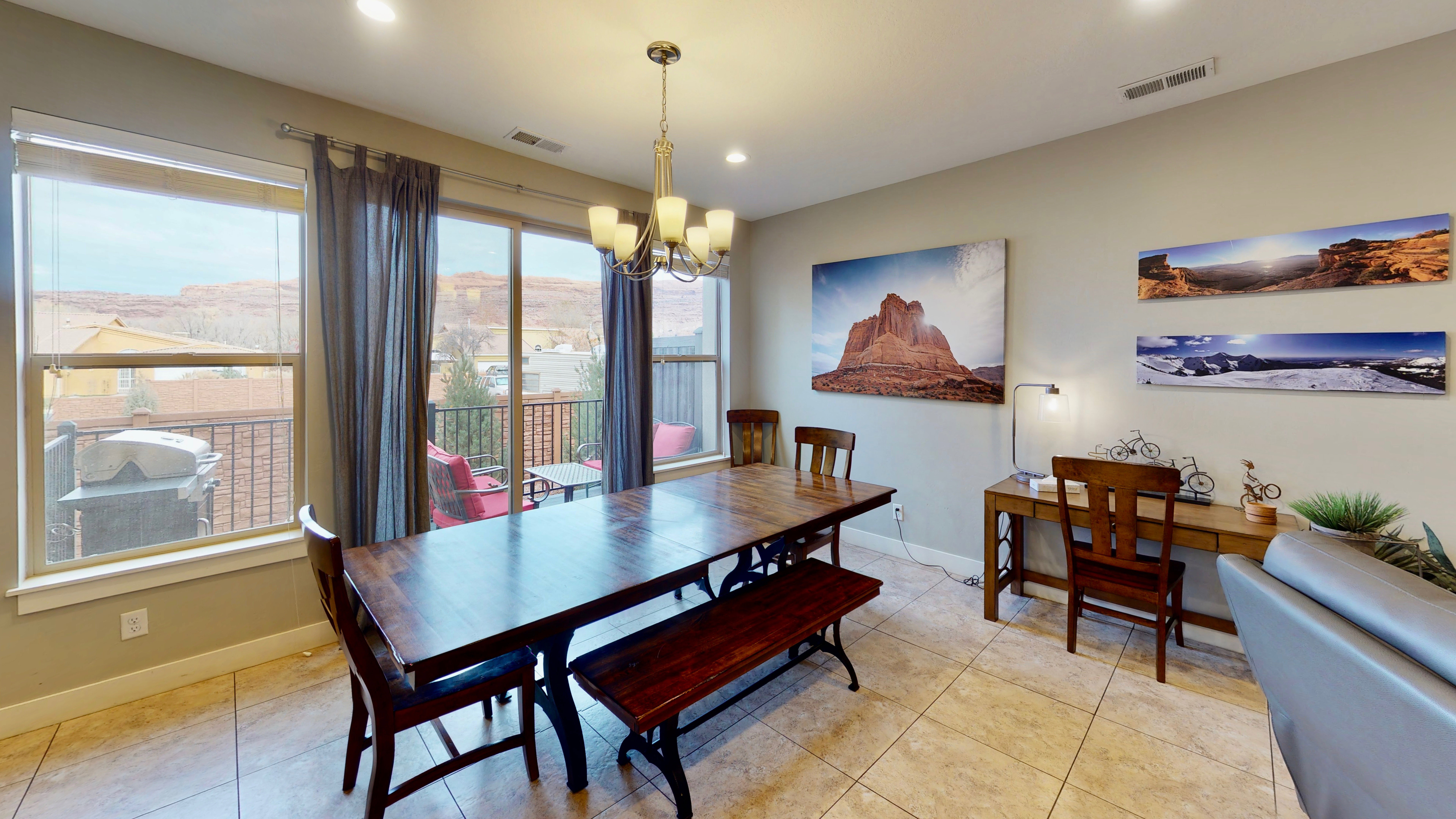Dining area with tile flooring and a multi-light chandelier