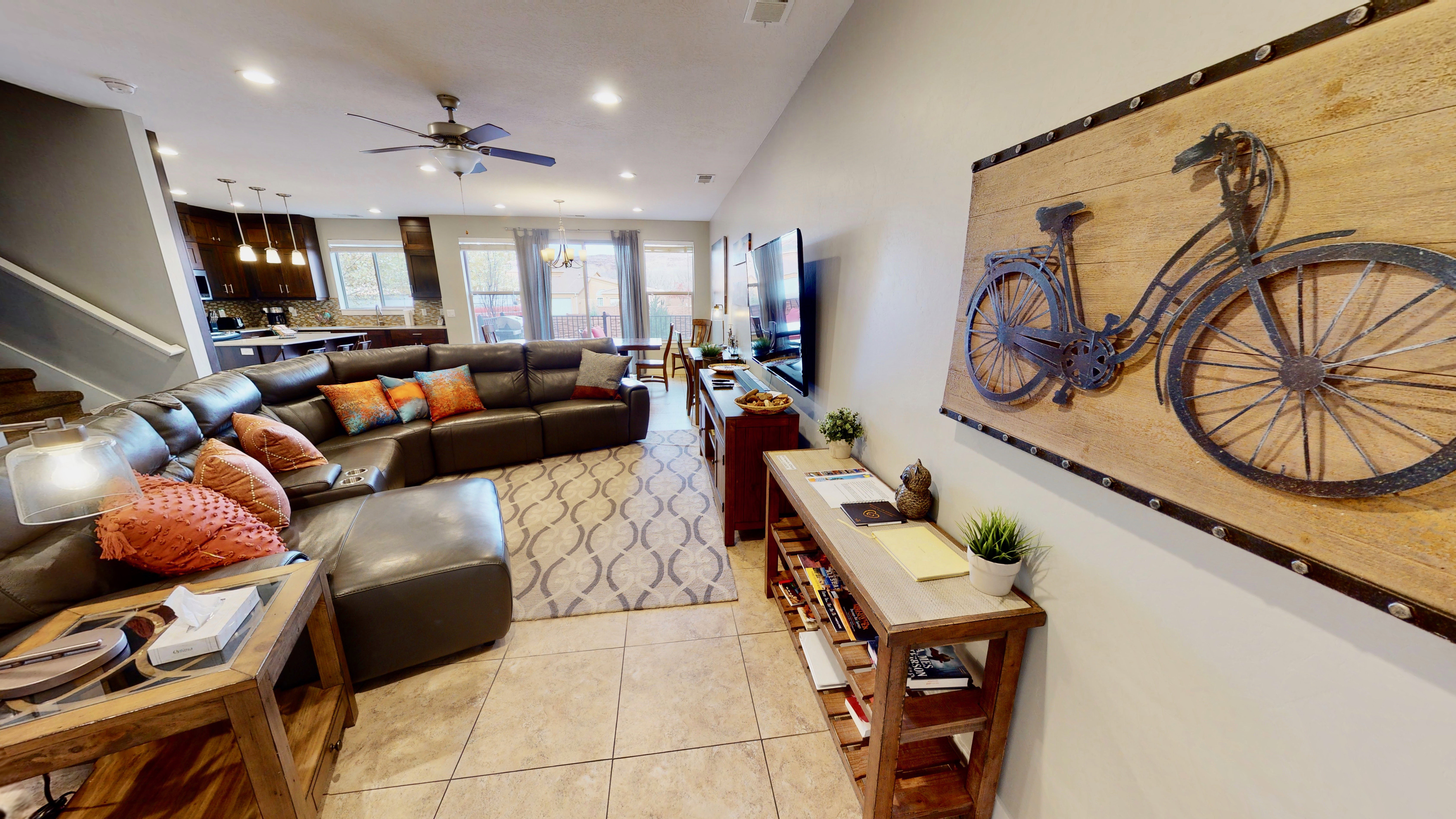 Open-concept living area featuring tile flooring, recessed lighting, and a ceiling fan