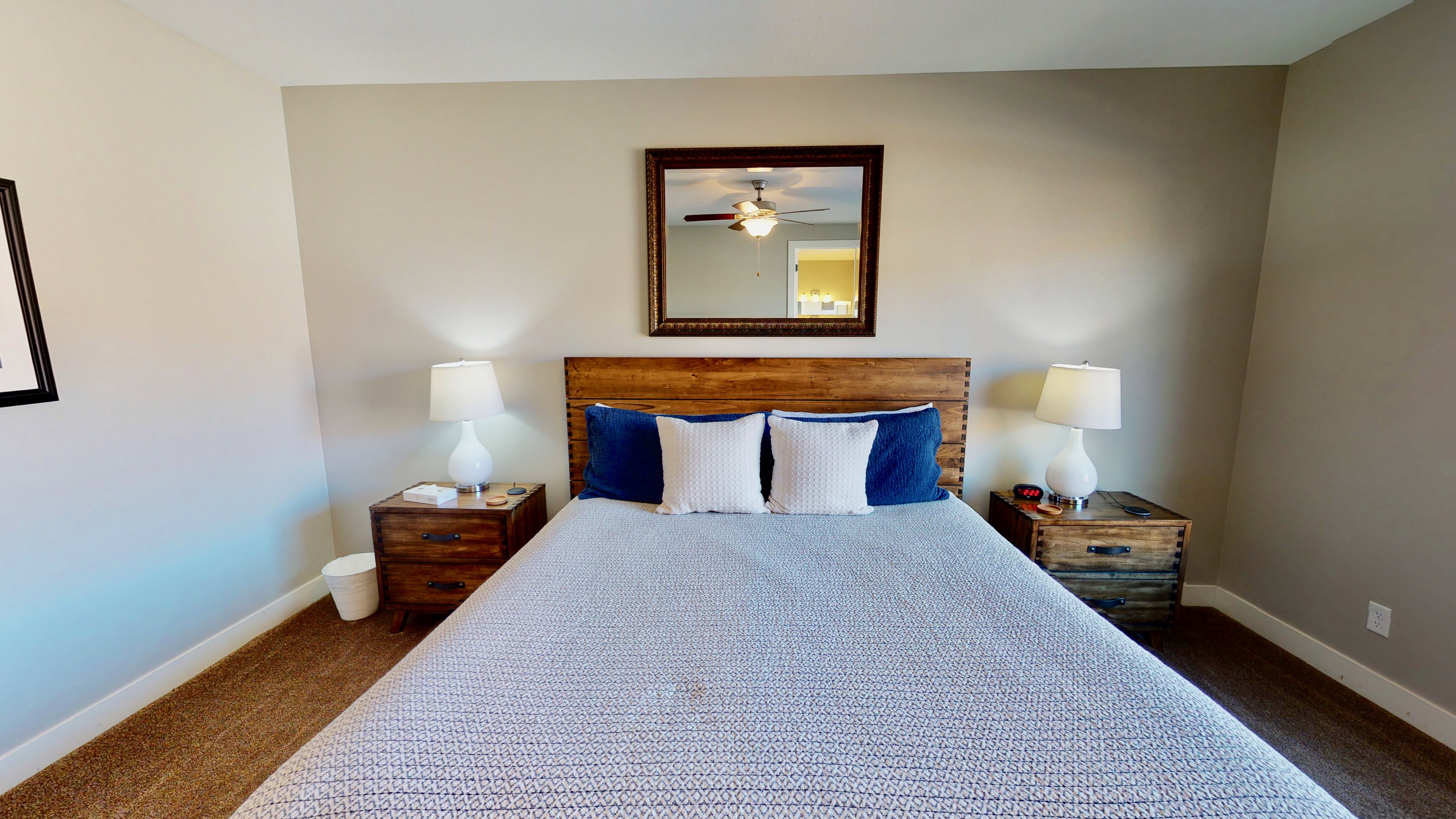 Bedroom featuring wood-finish headboard and textured carpeting
