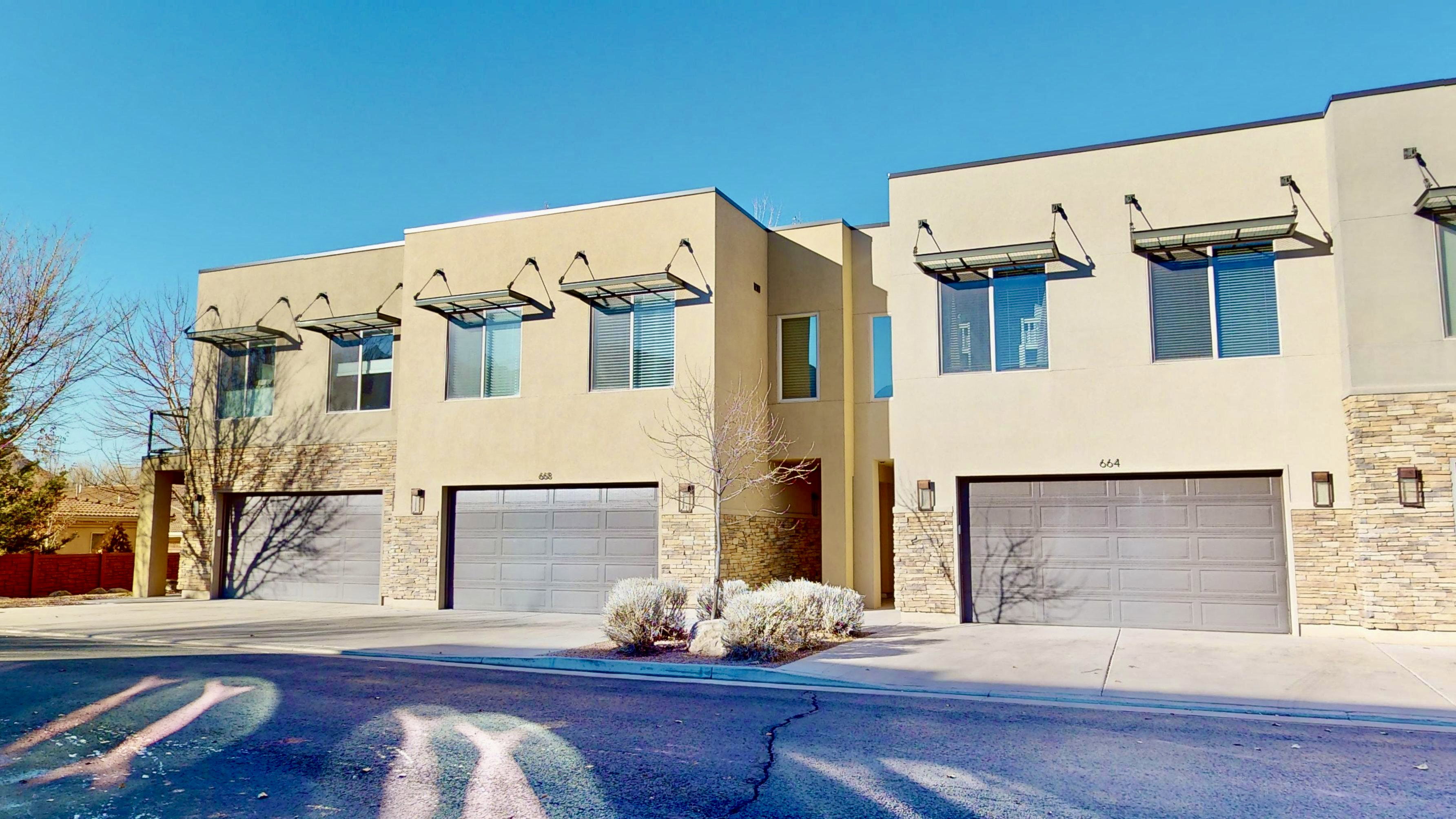 Modern facade featuring stucco siding and stone accents