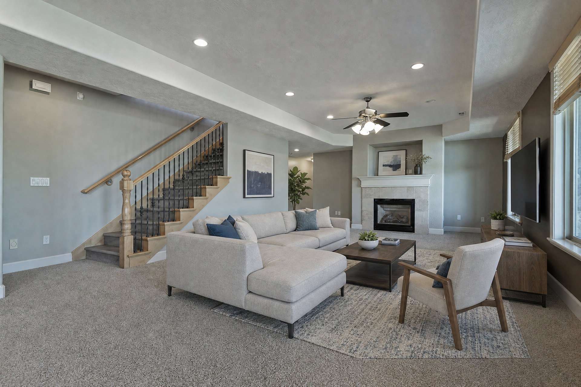 Spacious living area featuring a central fireplace with a stone surround, recessed lighting, a ceiling fan, and carpet flooring