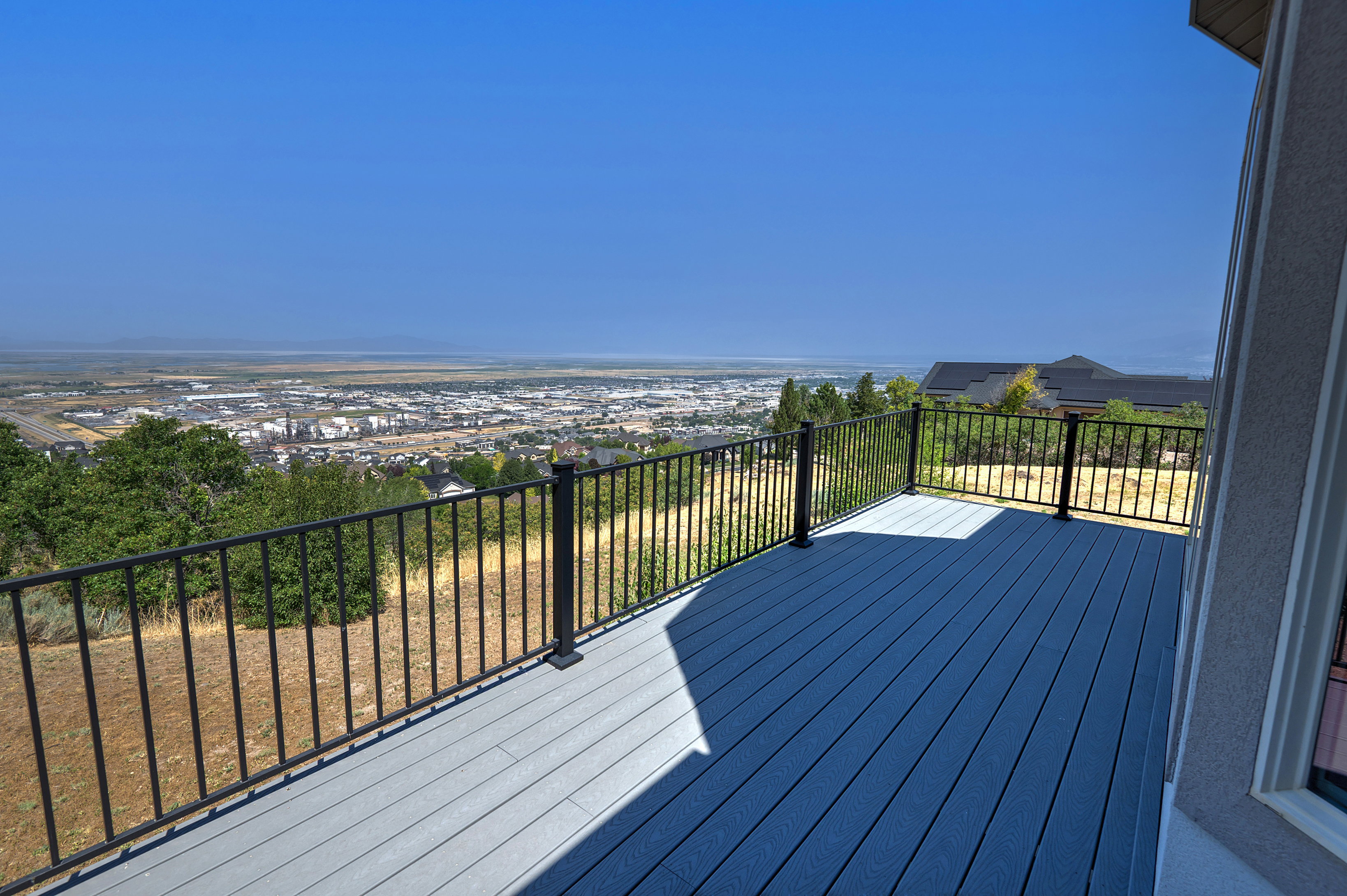 Expansive outdoor deck featuring composite decking and black metal railings