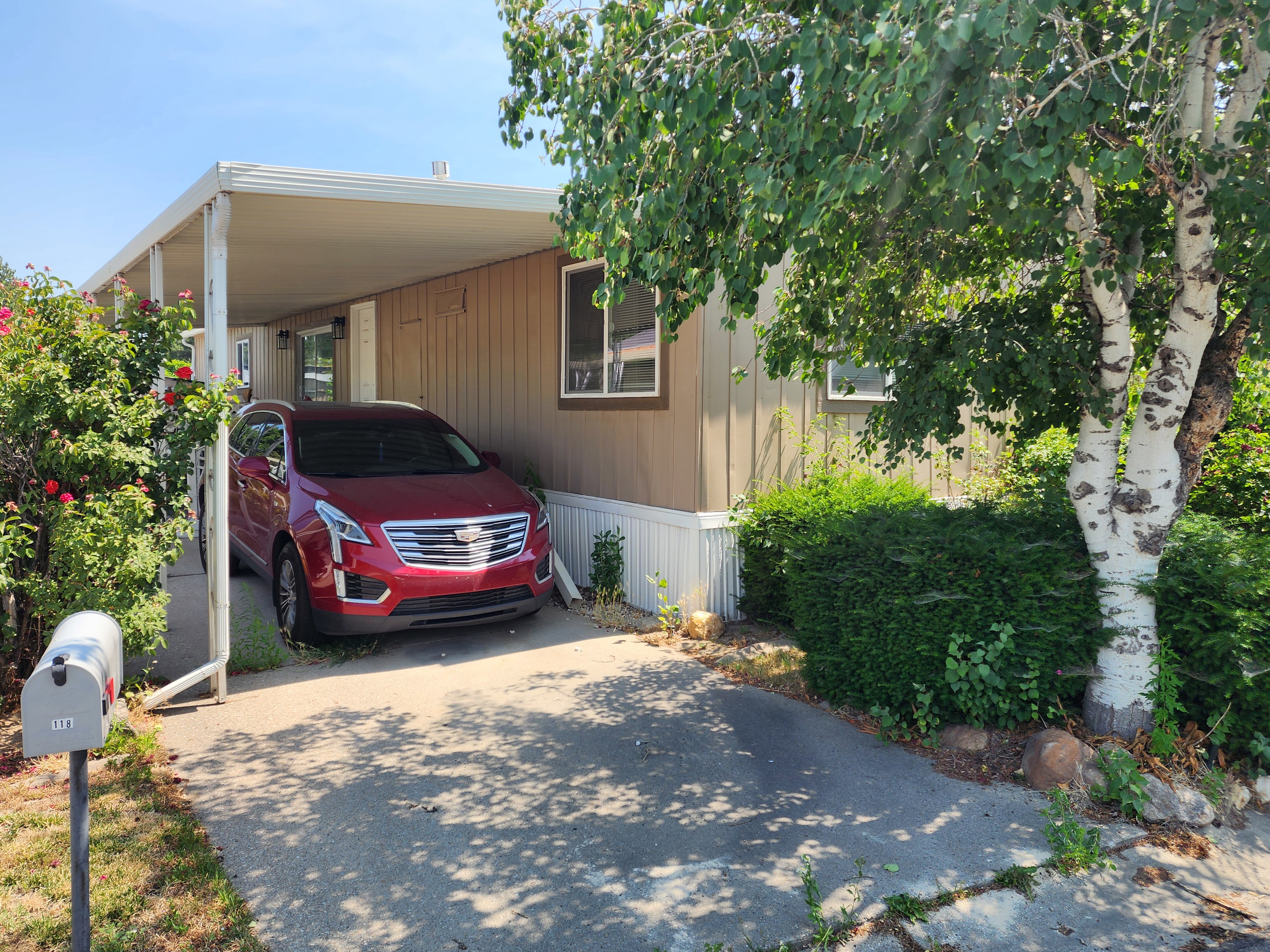 Carport entrance with a paved driveway