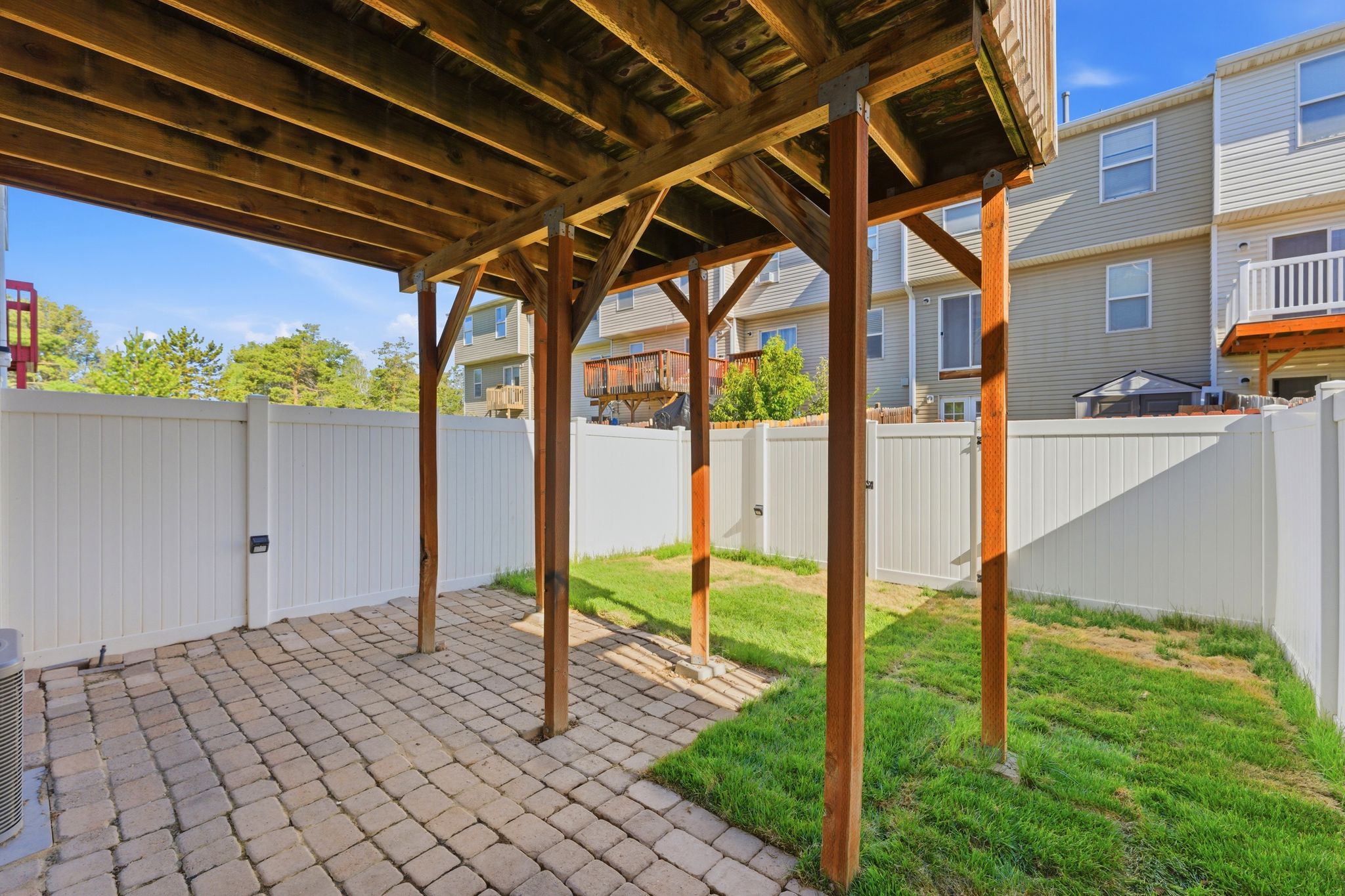 Covered patio area featuring paver stone flooring