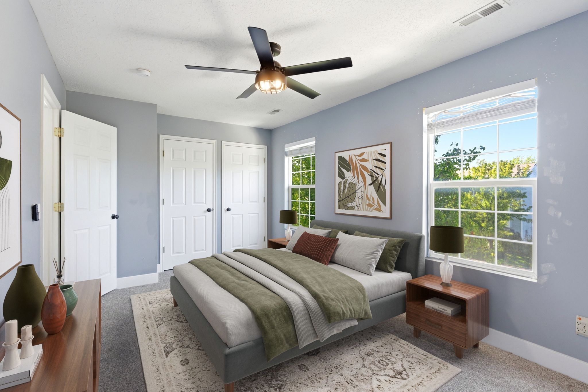 Virtually Staged Bedroom featuring twin windows, a ceiling fan with integrated lighting, and two panel doors