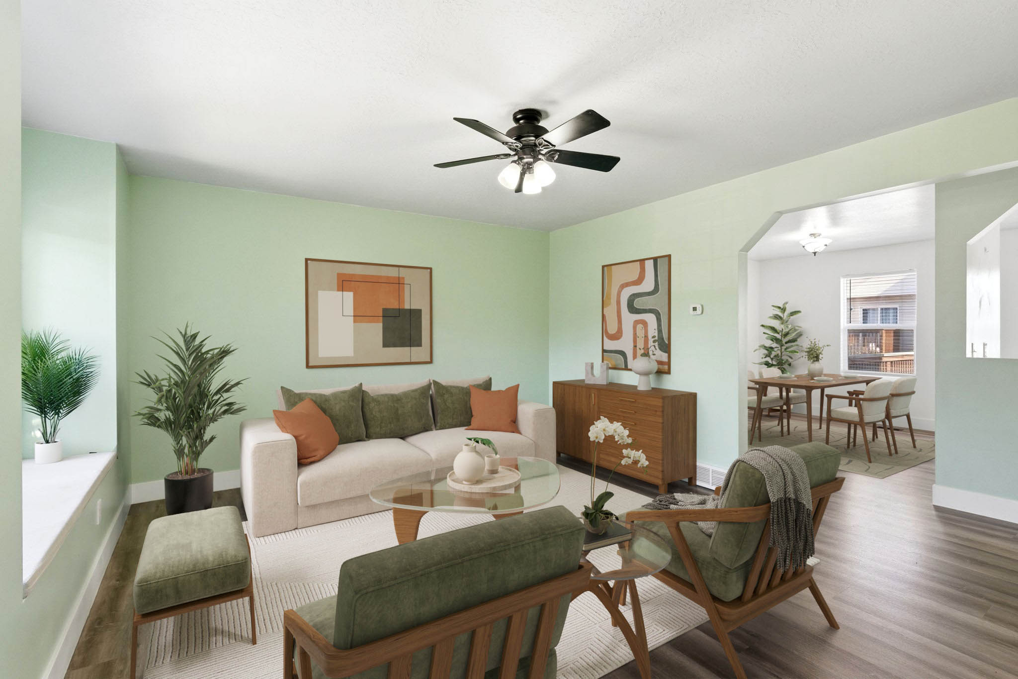 Light-filled living area featuring wood-finish flooring, a contemporary ceiling fan, and a wide window ledge