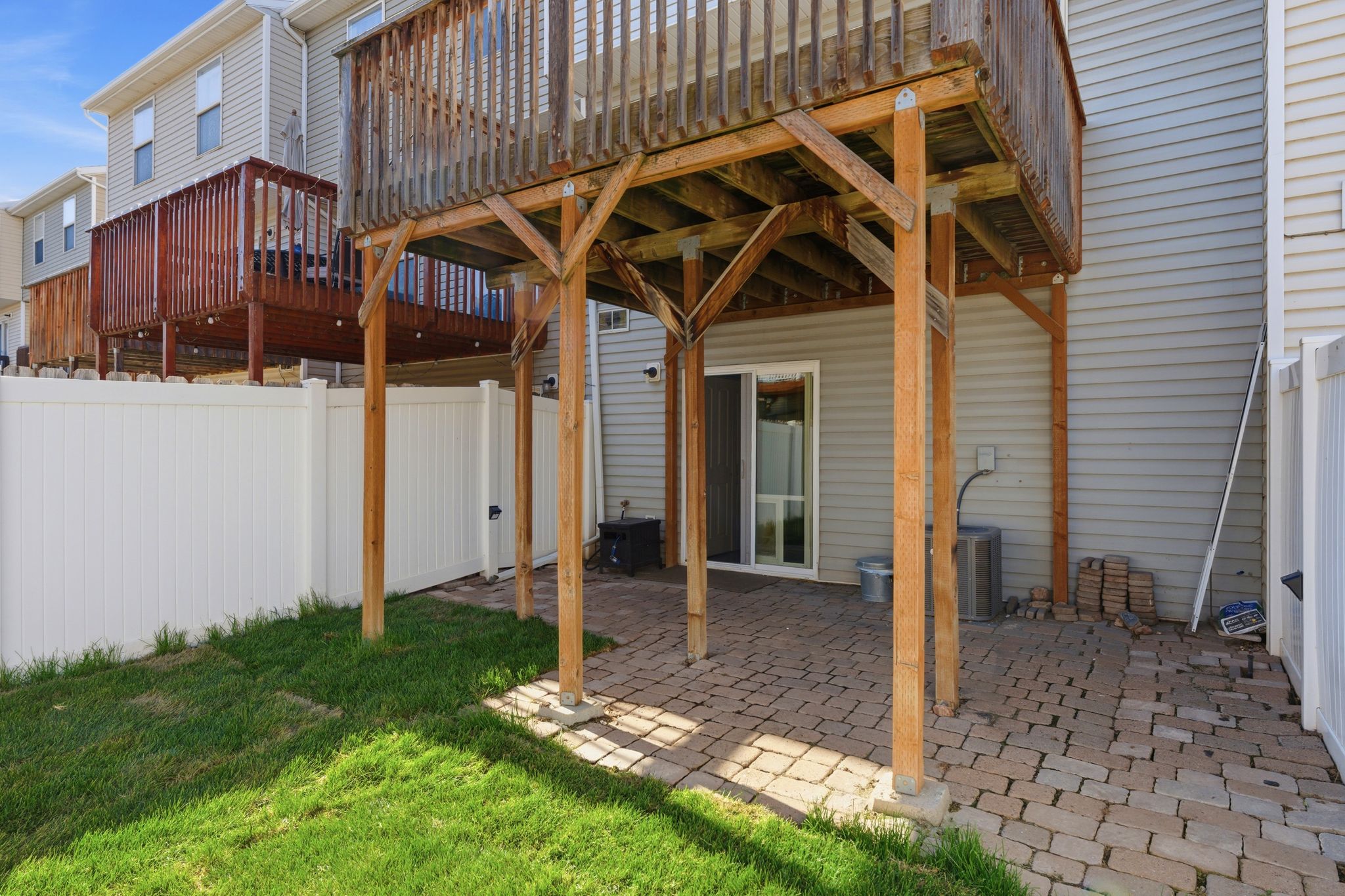 Two-story wood deck over a paver patio