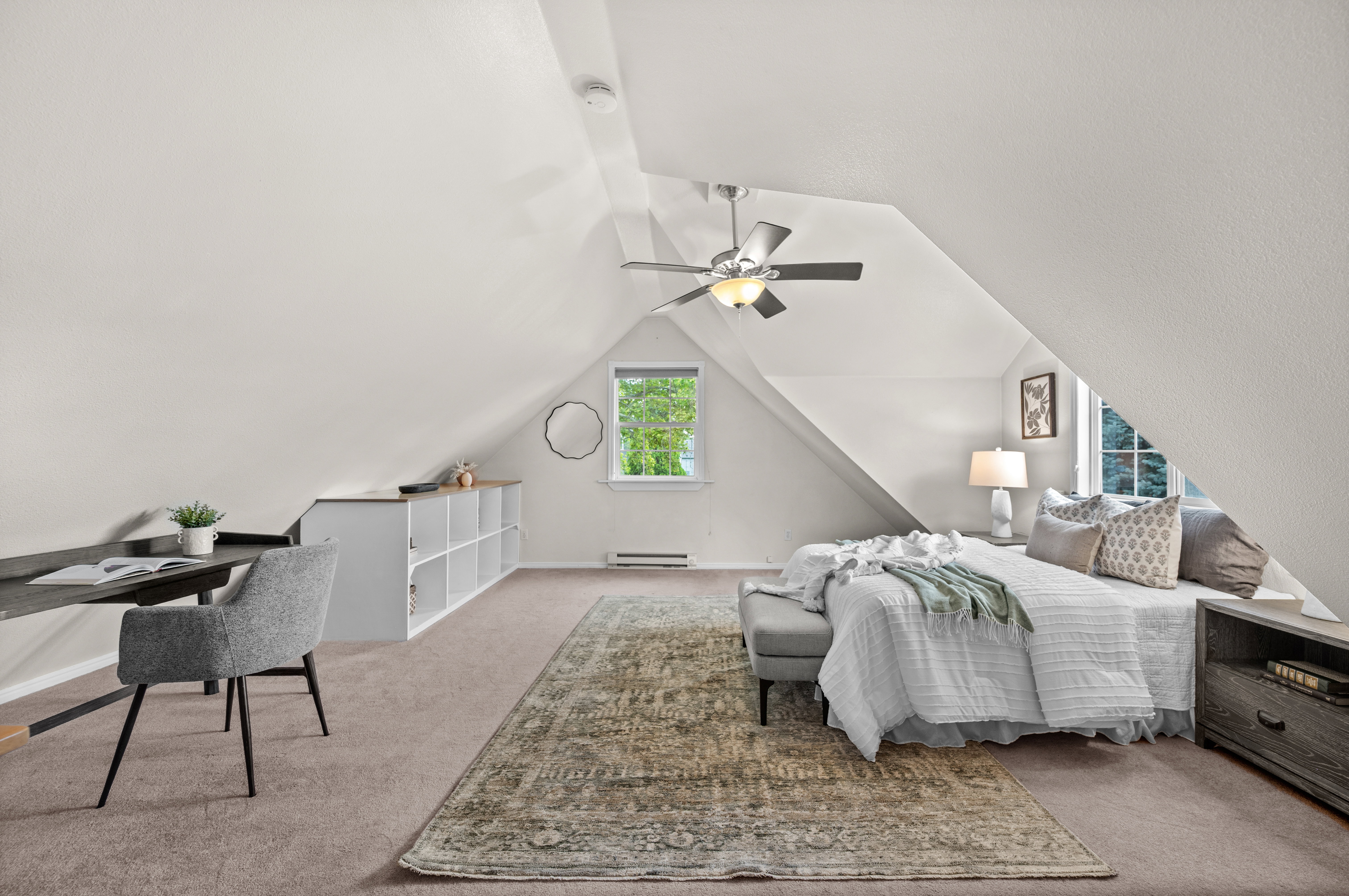 Carpeted room with sloped ceilings and recessed lighting