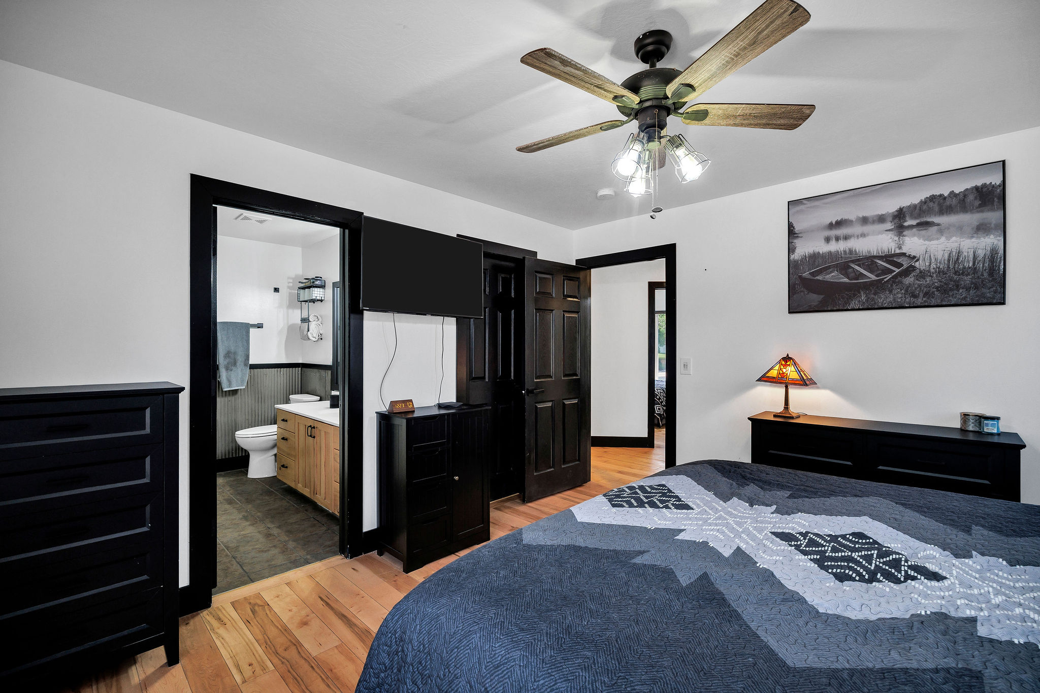 Hardwood flooring complements the bright white walls and dark trim