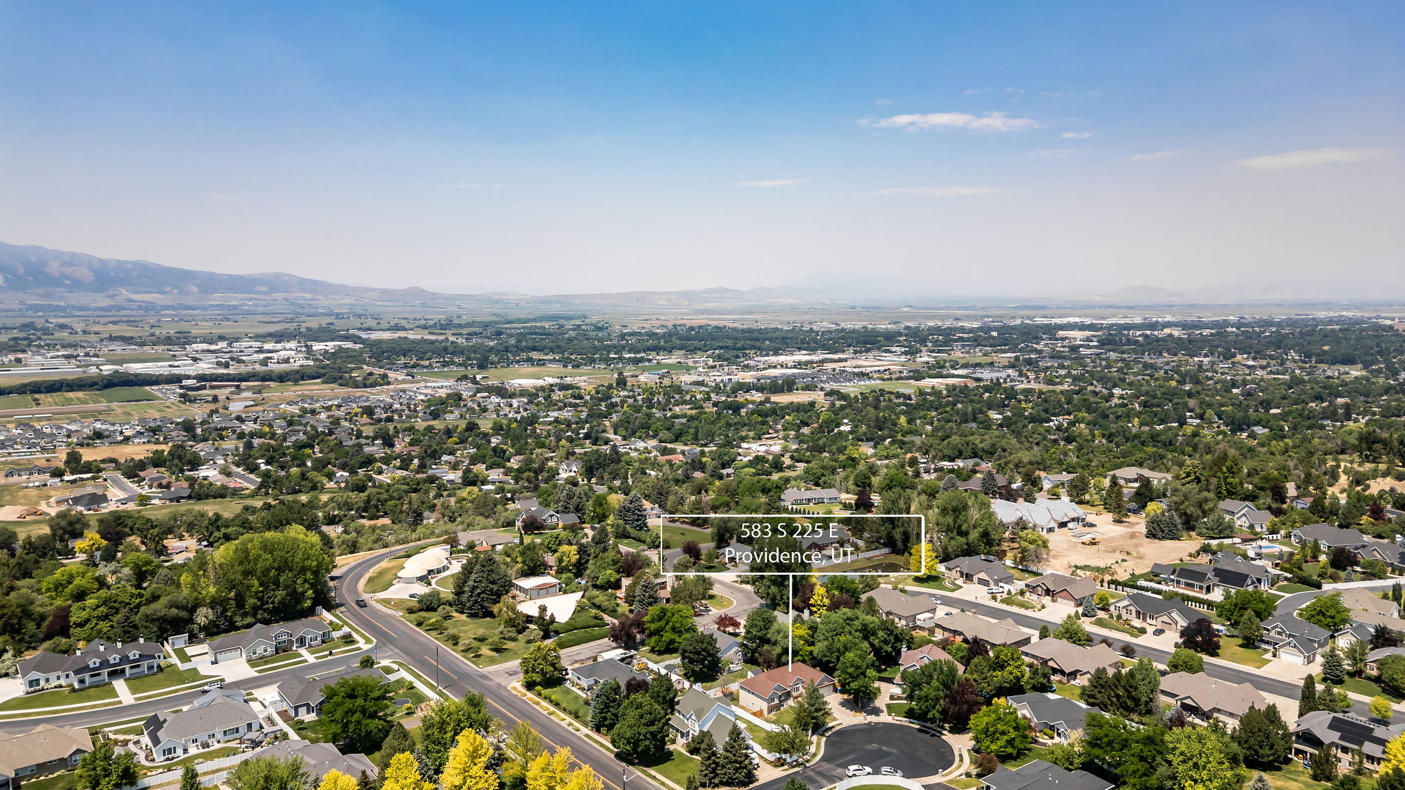 Aerial perspective highlighting the property within a residential neighborhood