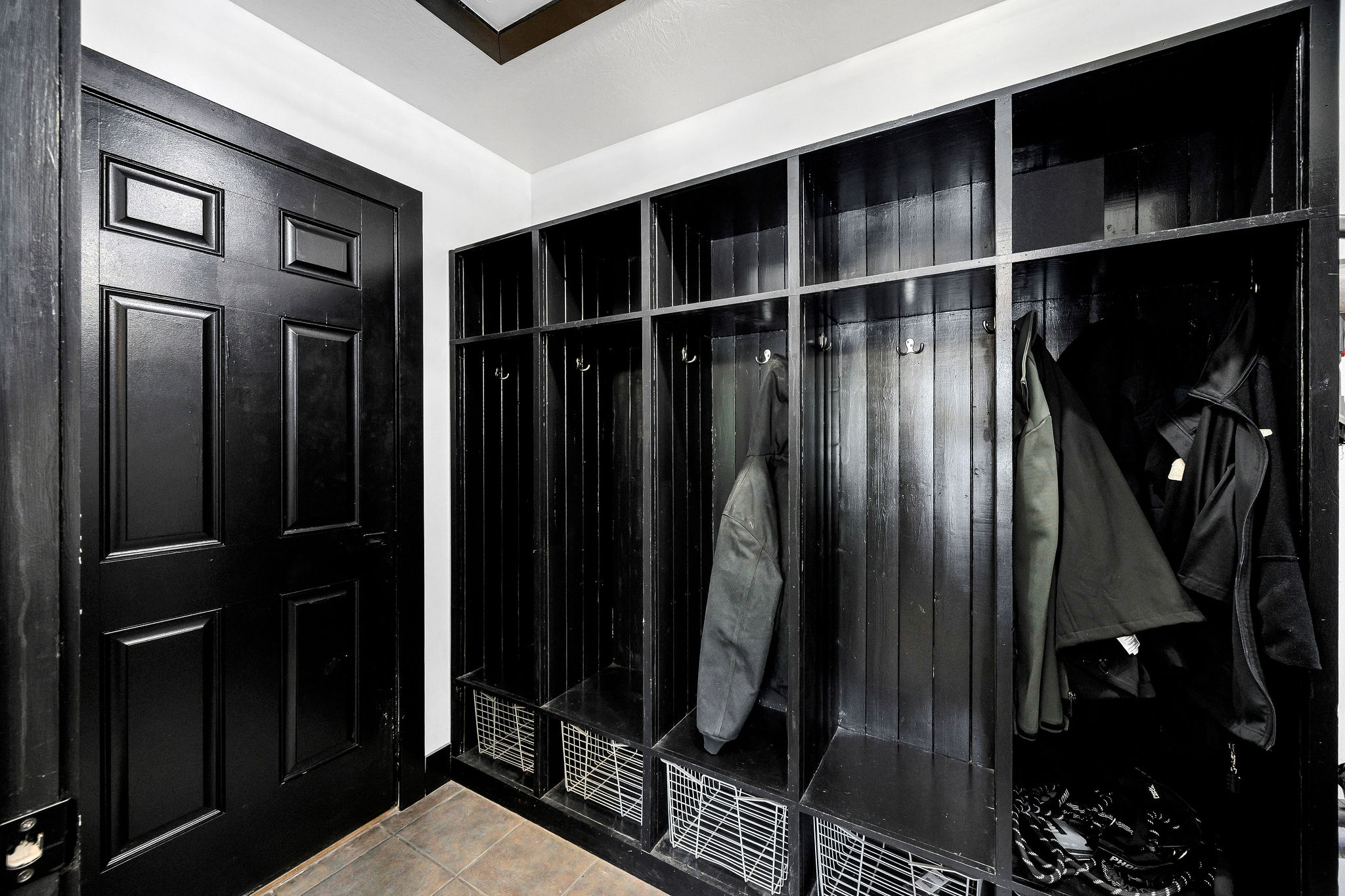 Built-in mudroom lockers with integrated storage, hooks, and shelving