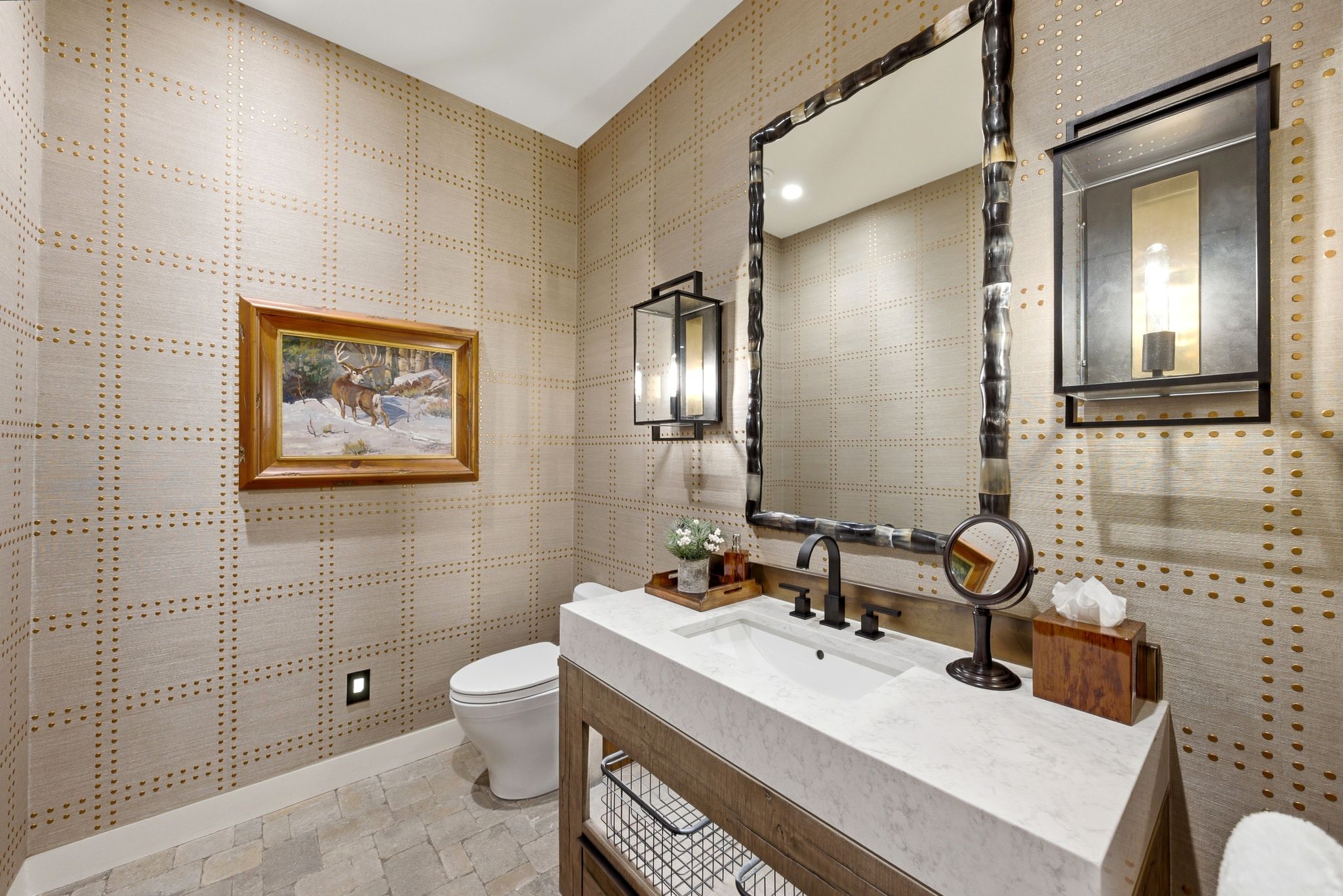 Vanity featuring a stone countertop, integrated sink, and dark bronze-finish fixtures