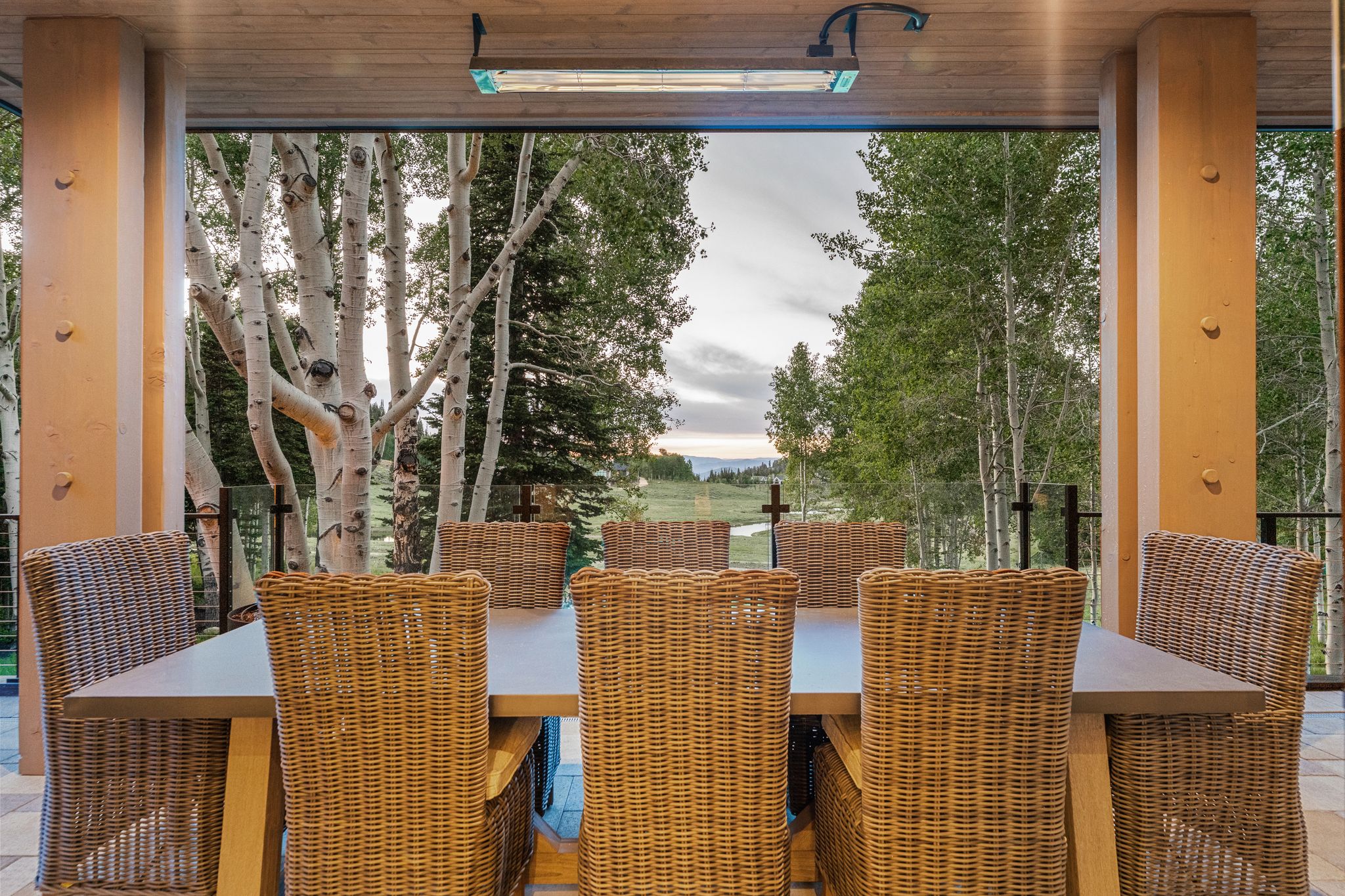 Covered outdoor dining area featuring a wood plank ceiling and recessed lighting