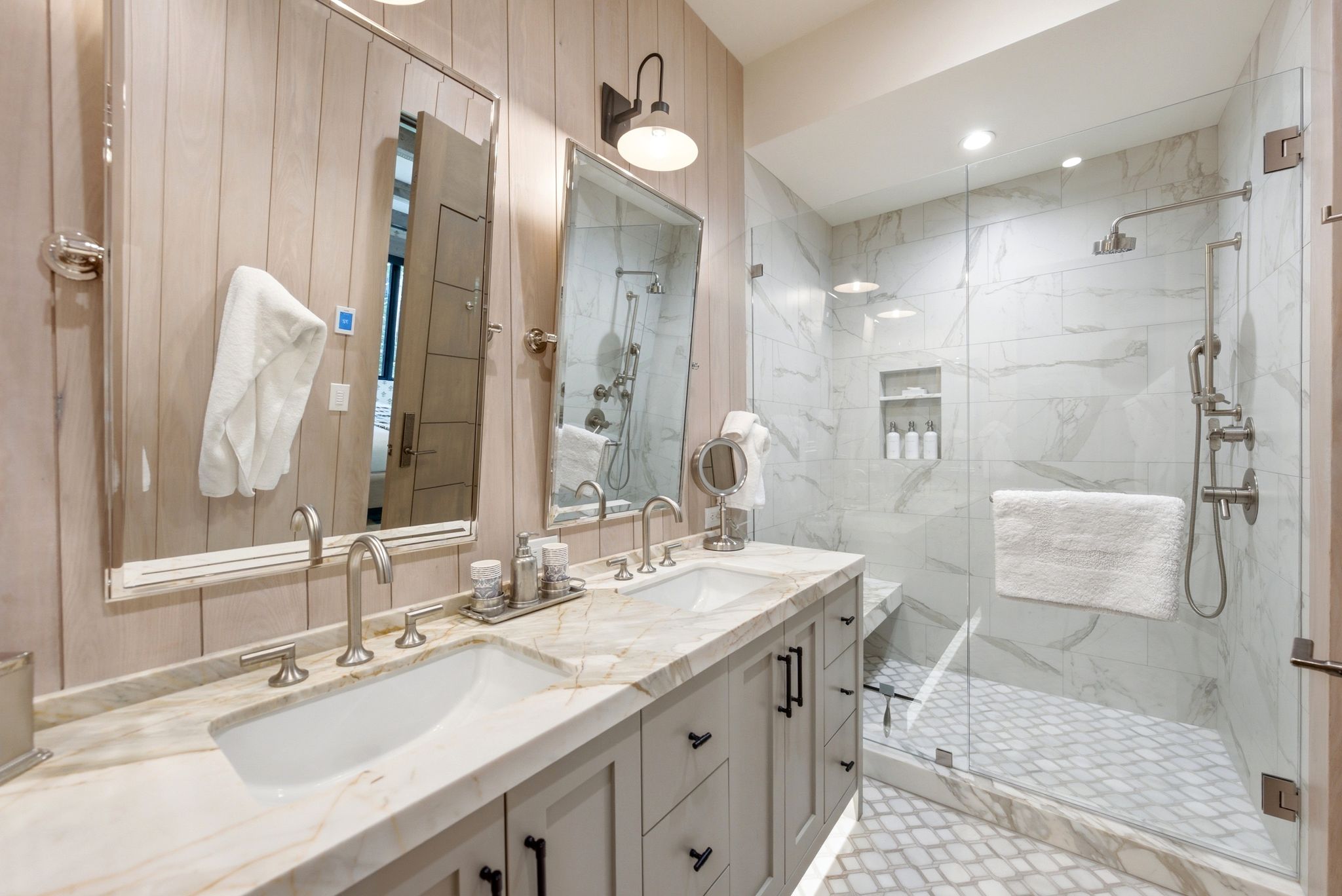 Bathroom featuring a dual vanity with undermount sinks, stone countertops, and brushed nickel fixtures