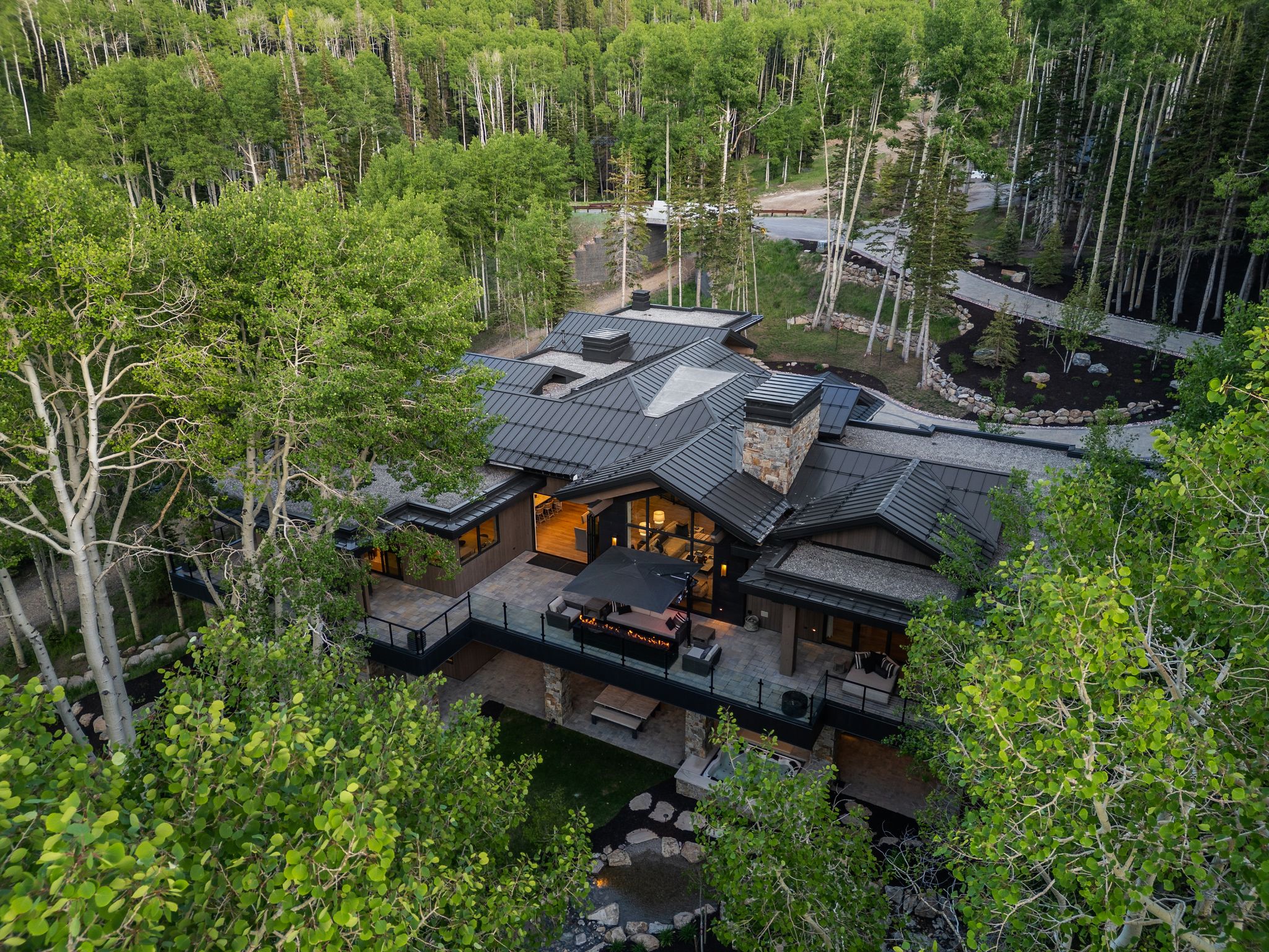 Contemporary residence featuring a multi-level design and dark metal roofing