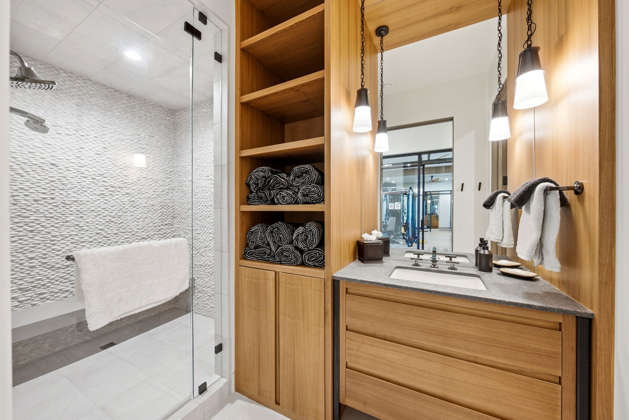 Walk-in shower with textured wall tile and rain showerhead