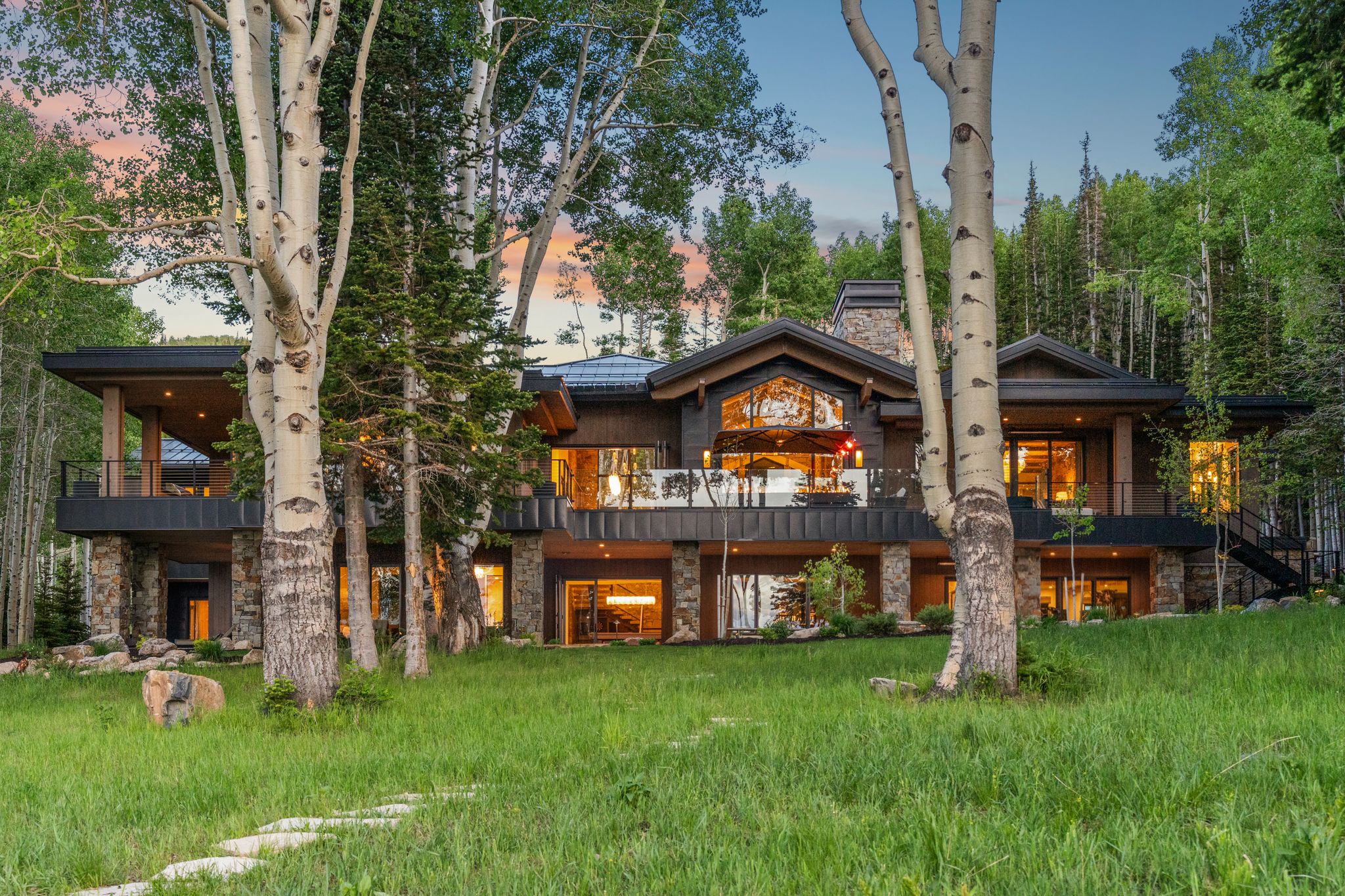 Contemporary mountain home featuring expansive stone and wood siding