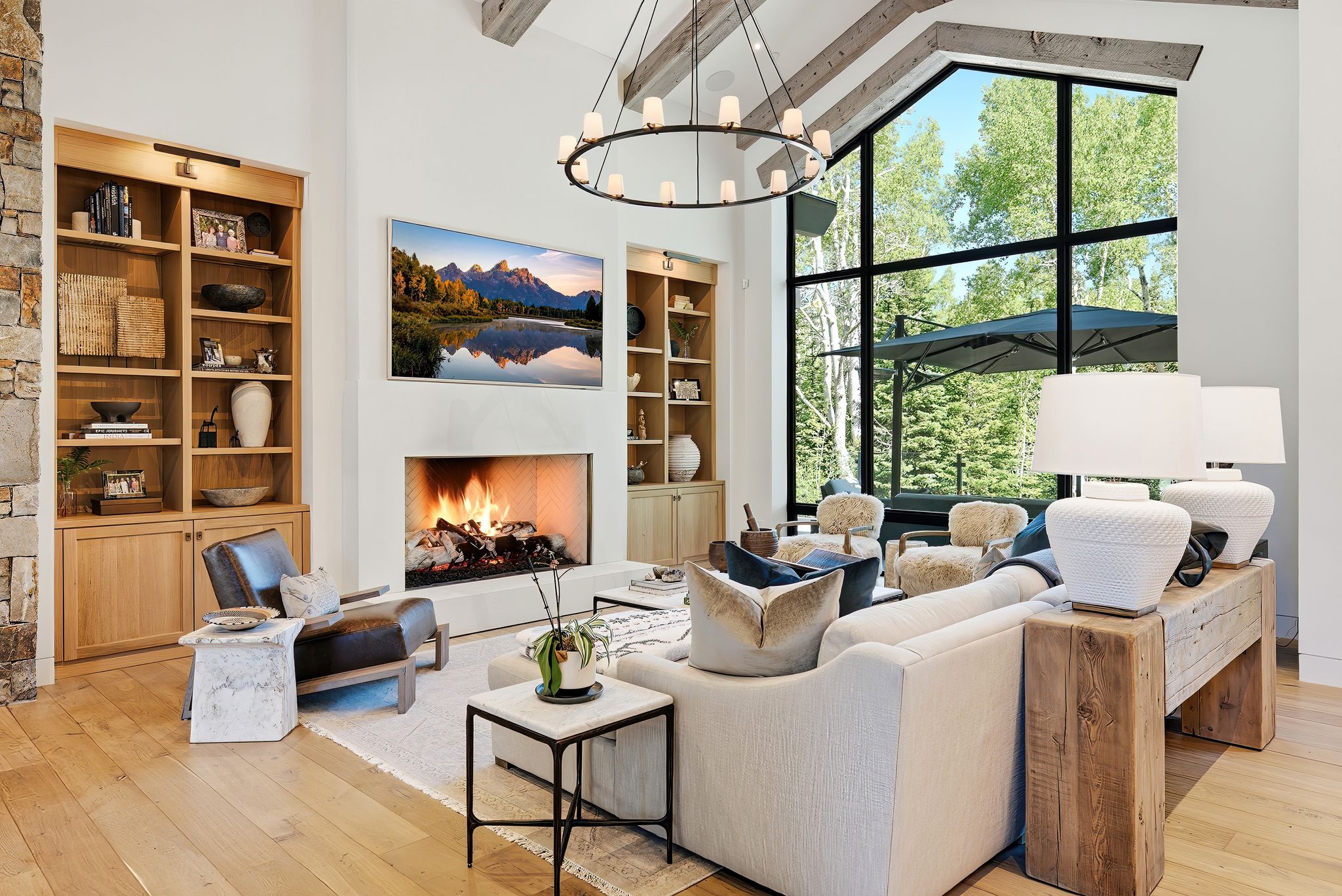 Vaulted ceilings featuring exposed wood beams enhance the living area