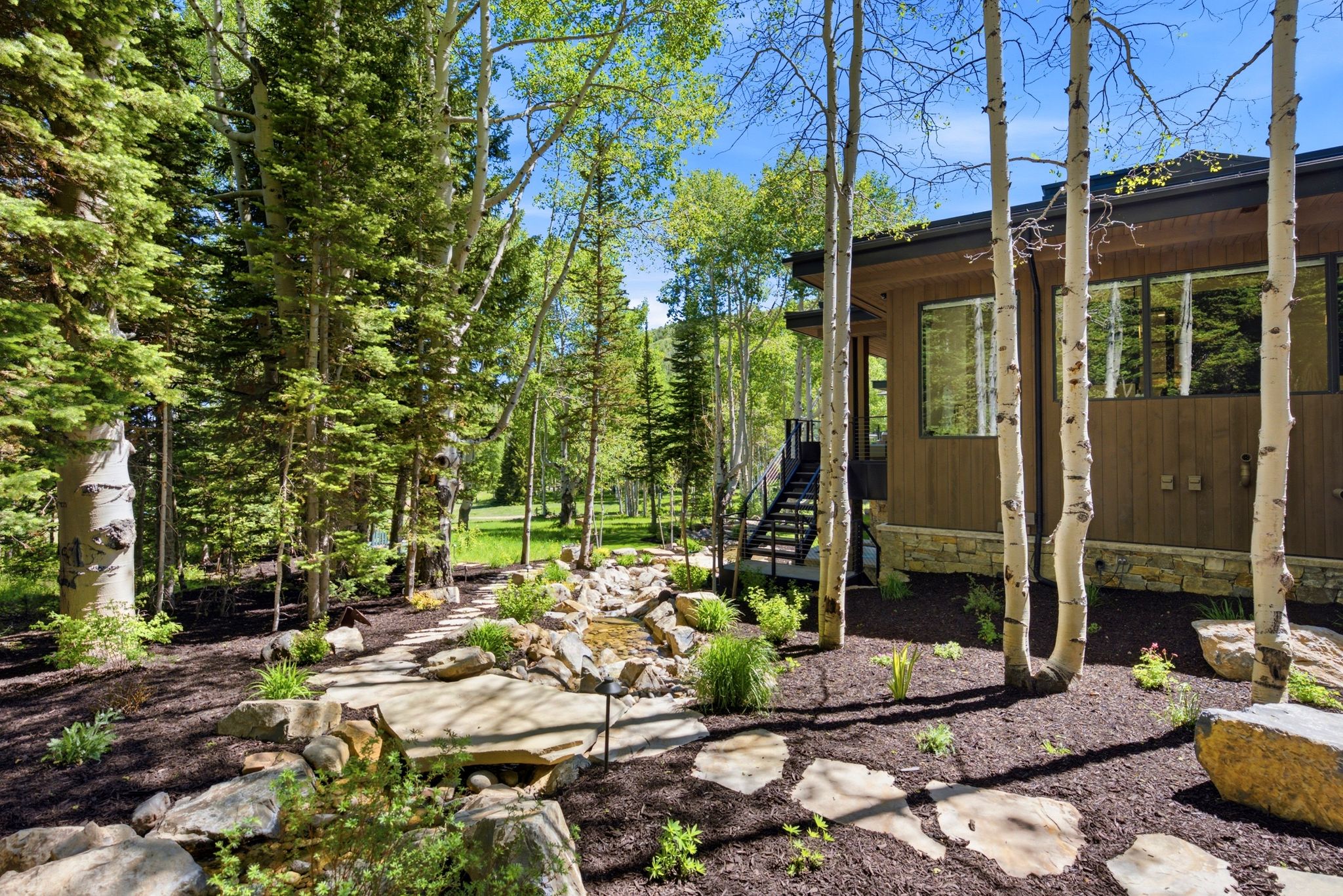 Exterior showcasing wood siding and stone foundation