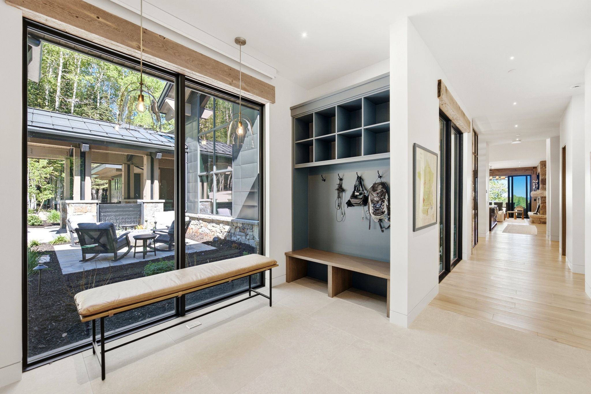 Entryway mudroom featuring built-in shelving, bench seating, and wall hooks