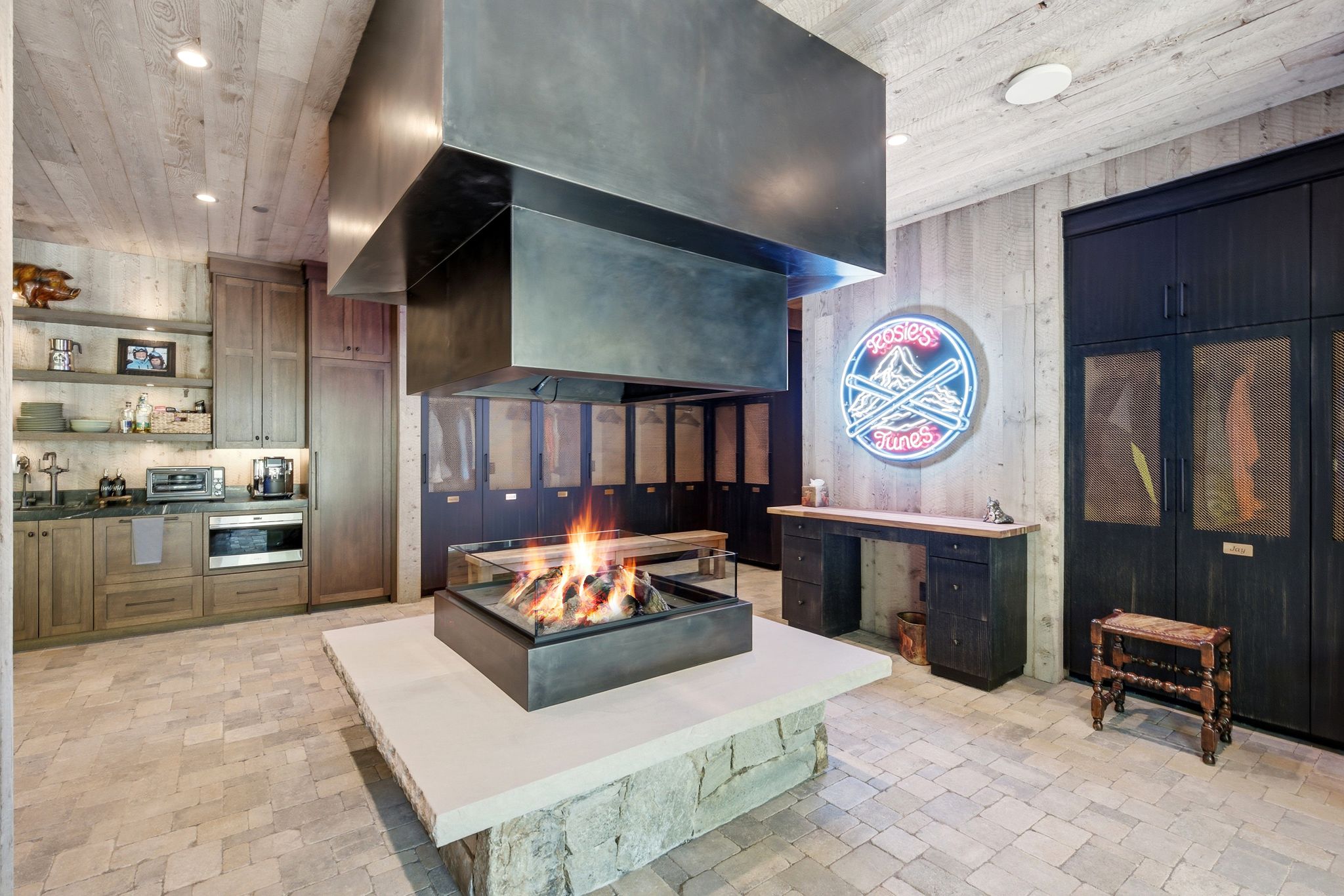 Central fire feature with stone base and metal surround