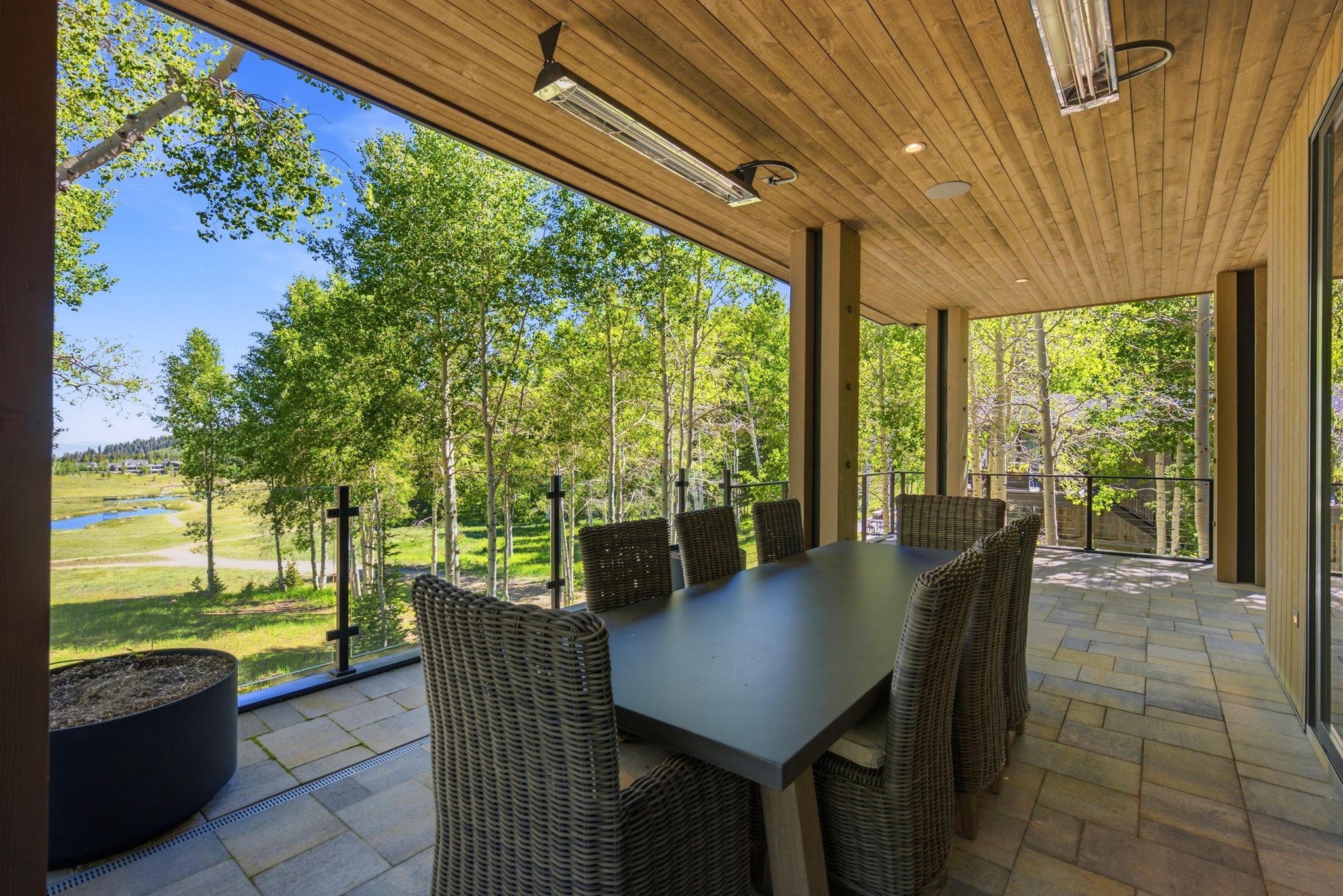 Covered outdoor patio featuring a wood-finish ceiling, recessed lighting, and patio heaters
