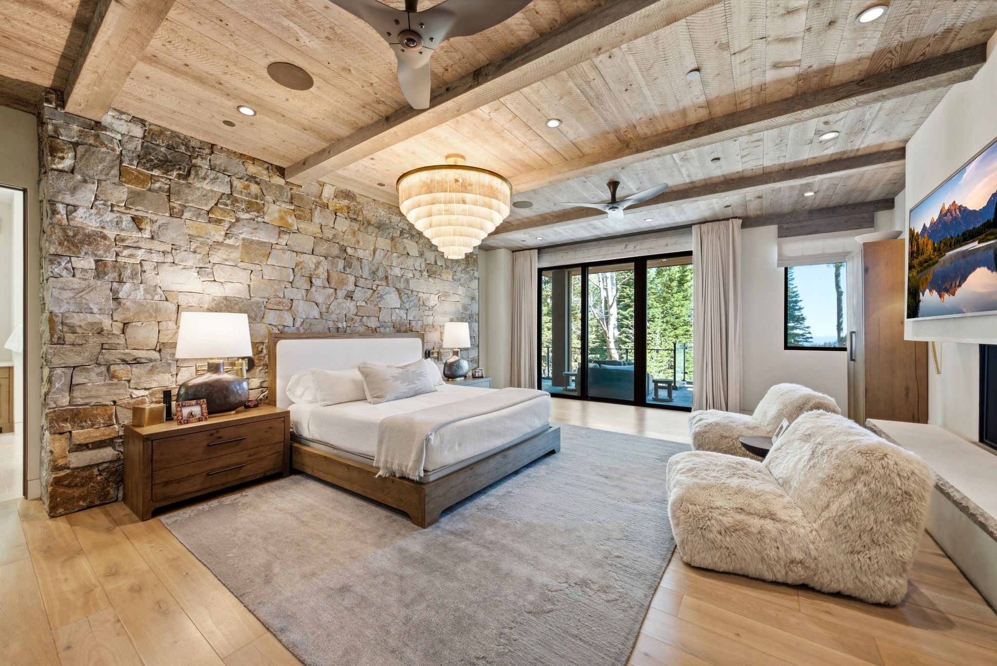 Stone accent wall with a wood-finish ceiling, exposed beams, and recessed lighting
